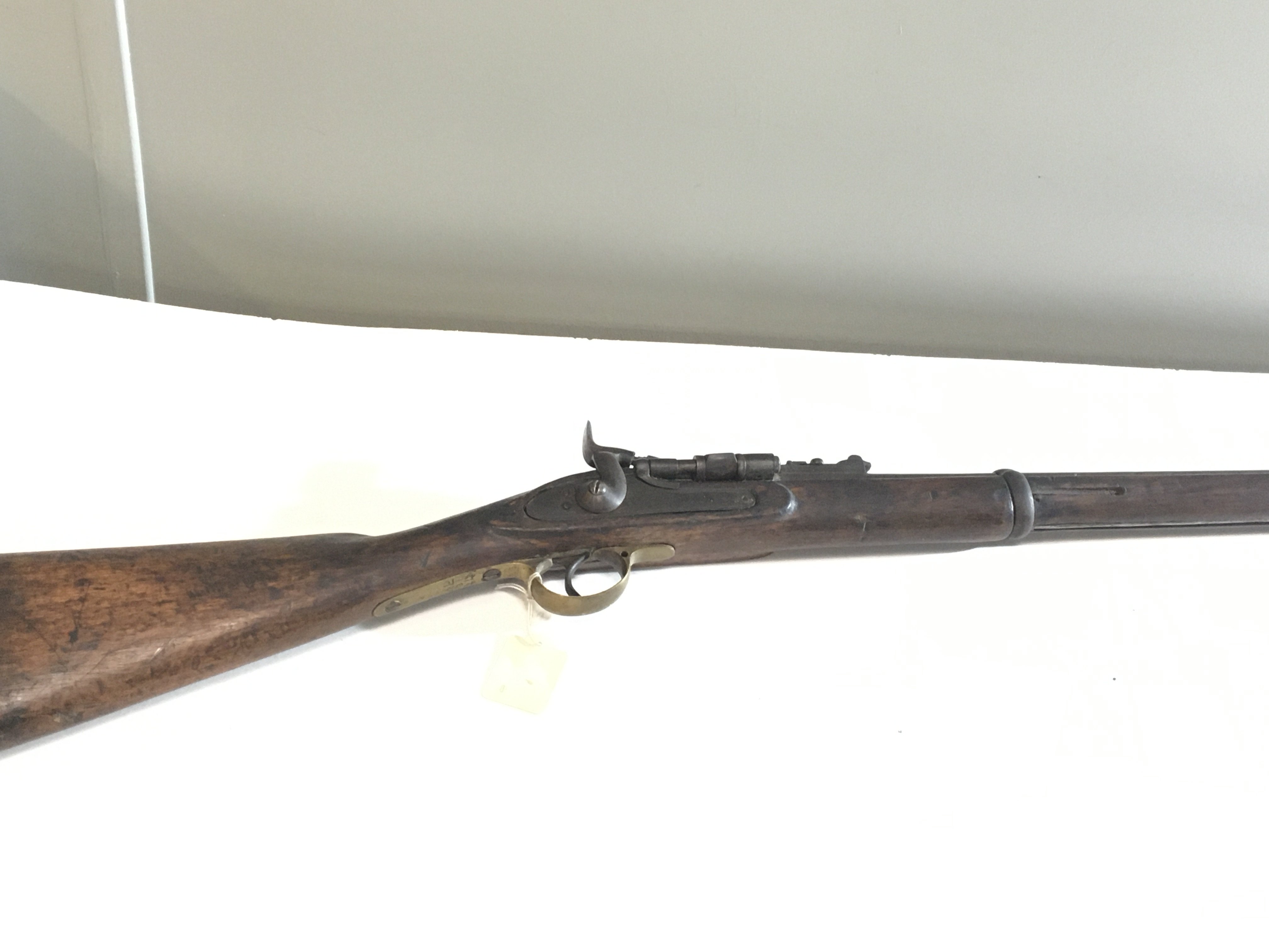 A 19th century Indian Military issue Rifle with brass trigger steel ram rod early breech loading mechanism. Indian military marks.