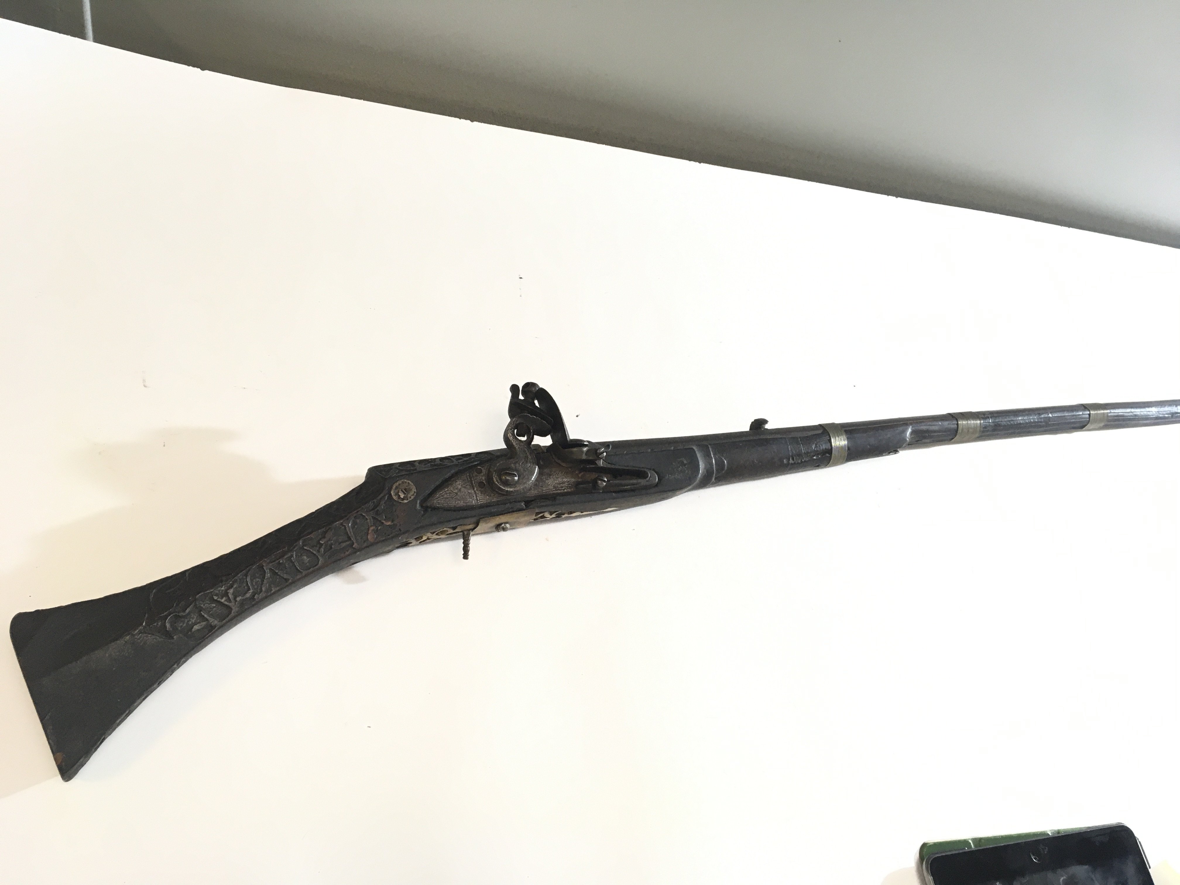 A 19th century Indian or North West Frontier Jezail flintlock rifle with a carved stock wired barrel.