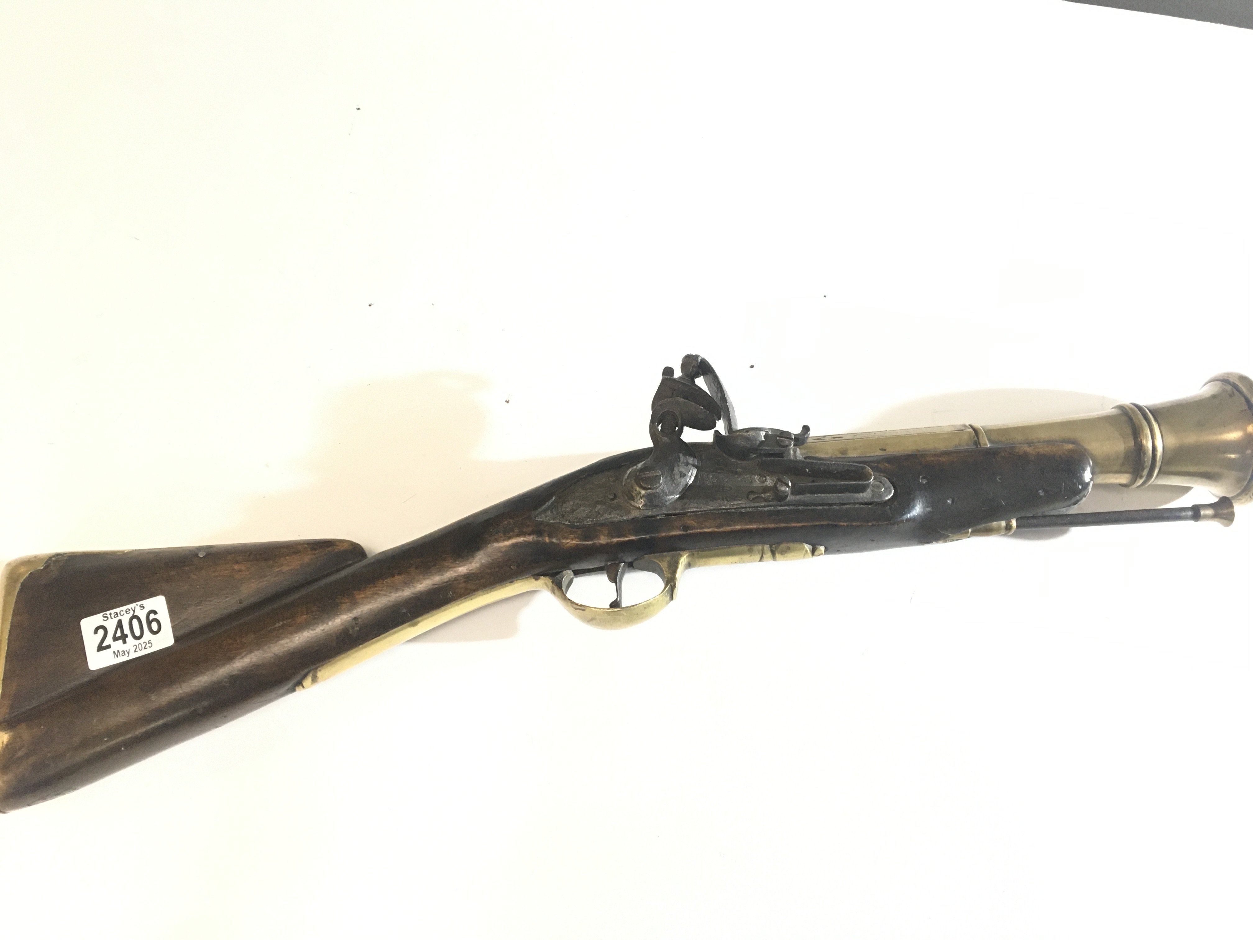 An 18th Century English brass barrel Blunderbuss flintlock most likely a coachmen&rsquo;s protection arm. With a wide opening flared barrel with turned end and some ornamentation brass fittings the action stamped with Royal Crown GR.