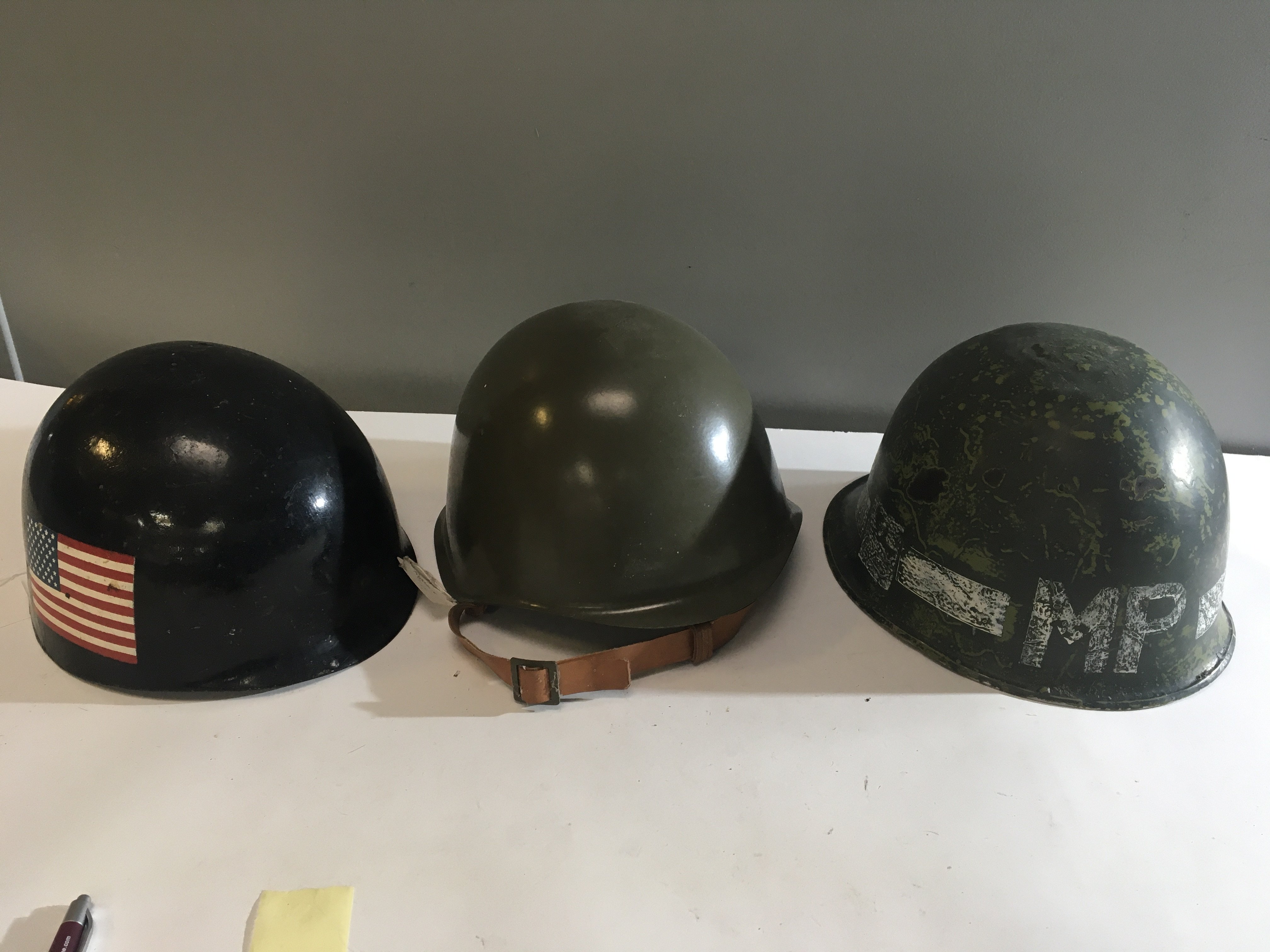 An American MP helmet one other with a painted American flag and a Russian type helmet (3)