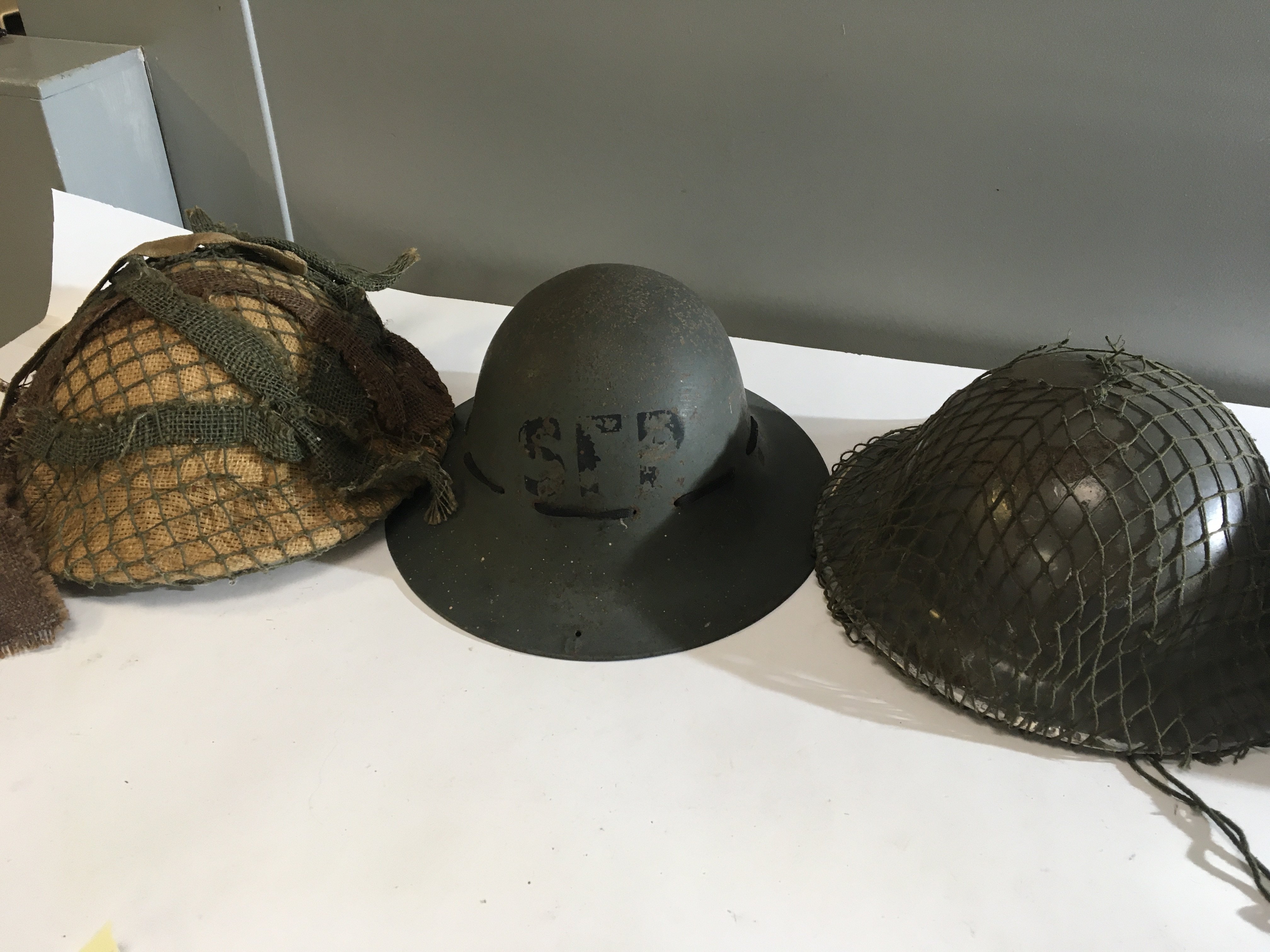 Four Military helmets an SFP home front British II world war helmet two other British helmets and a World War II Czechoslovak helmet (4)