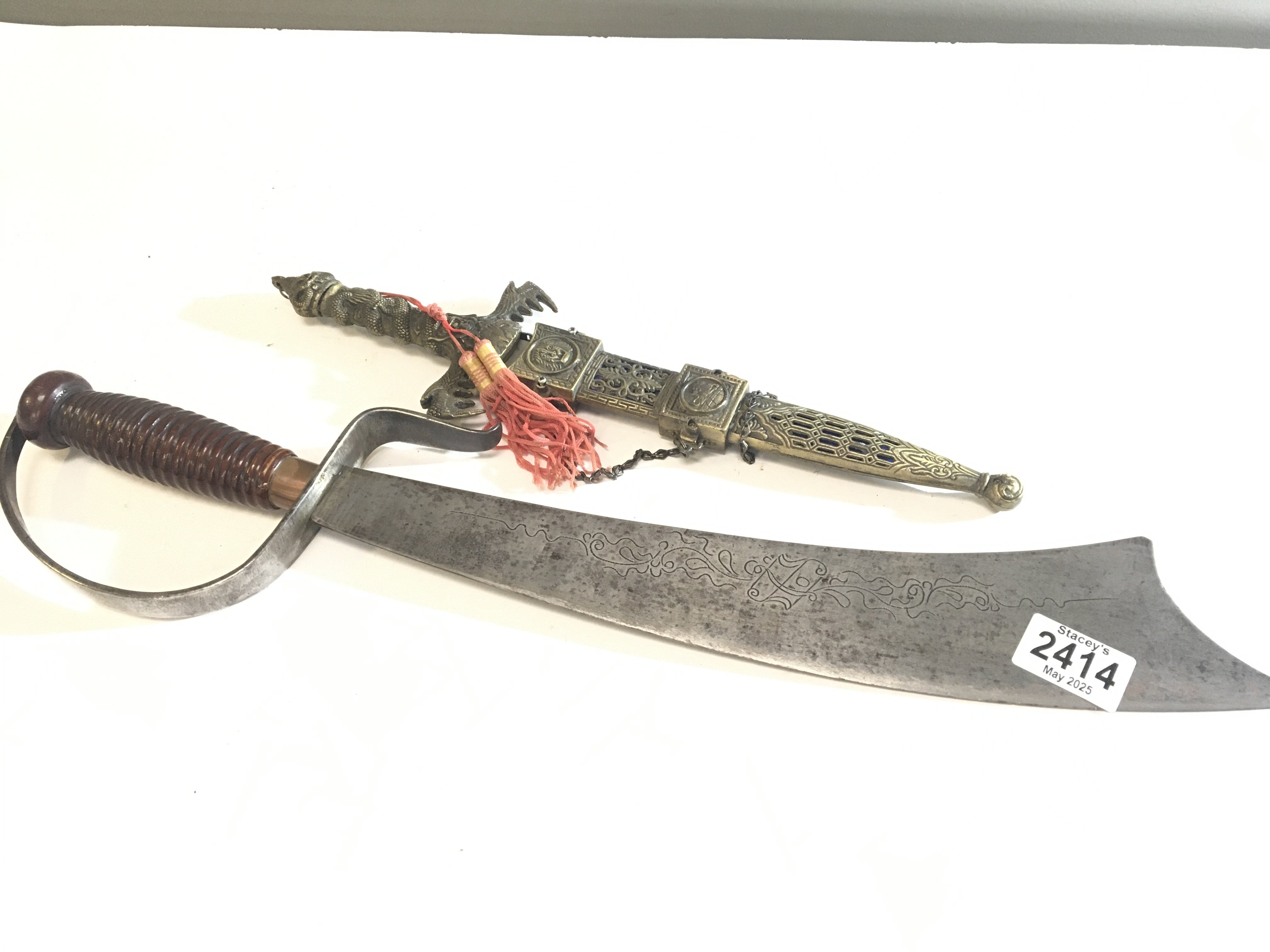 An Antique steel Indian Machete type steel knife with a wood grip and one other ornamental dagger (2)