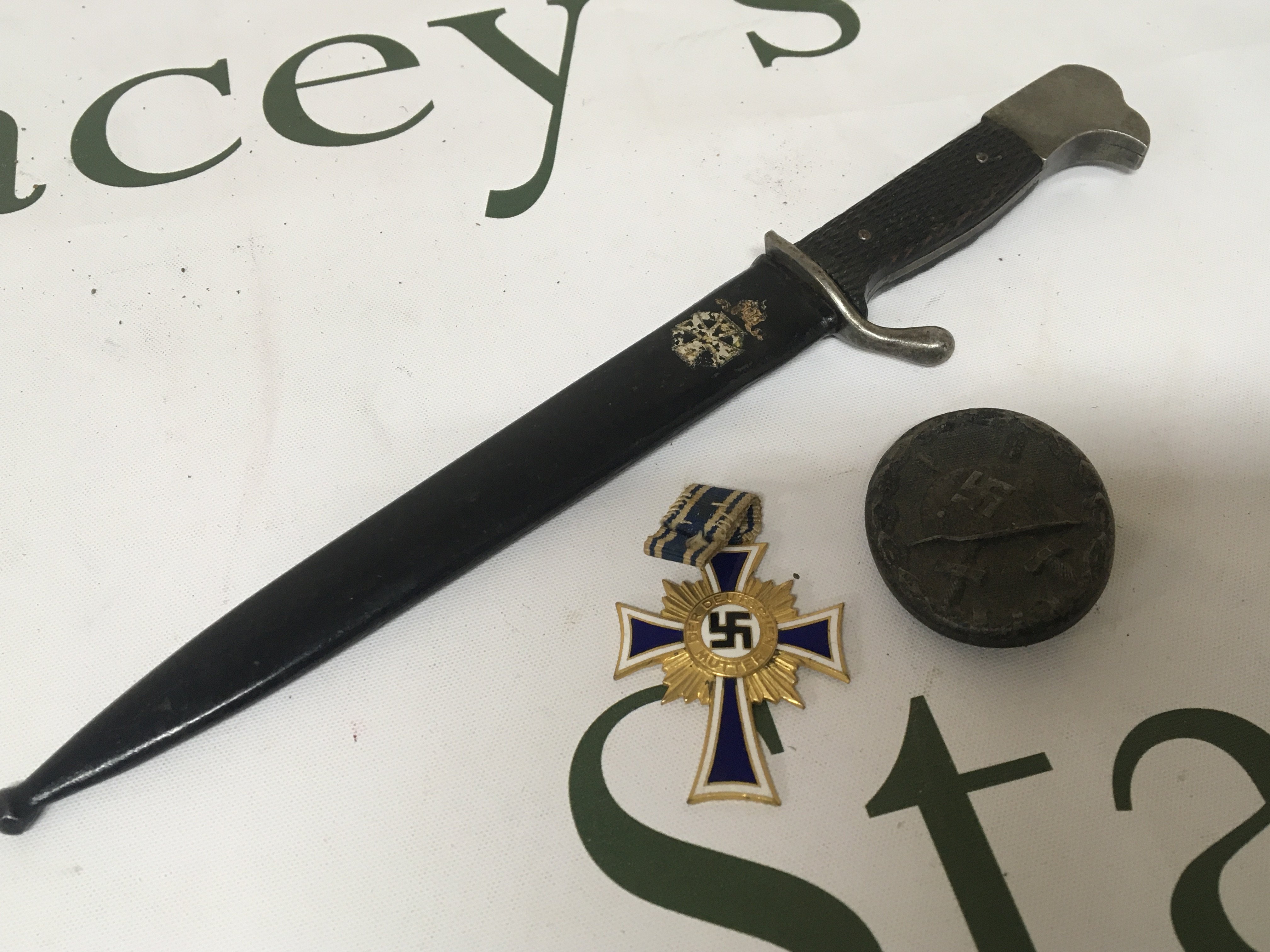 A German Third Reich paper knife, a German II world war wound badge and an enamel and gold Civil Cross of Honour given to Mothers of the third Reich. (3)