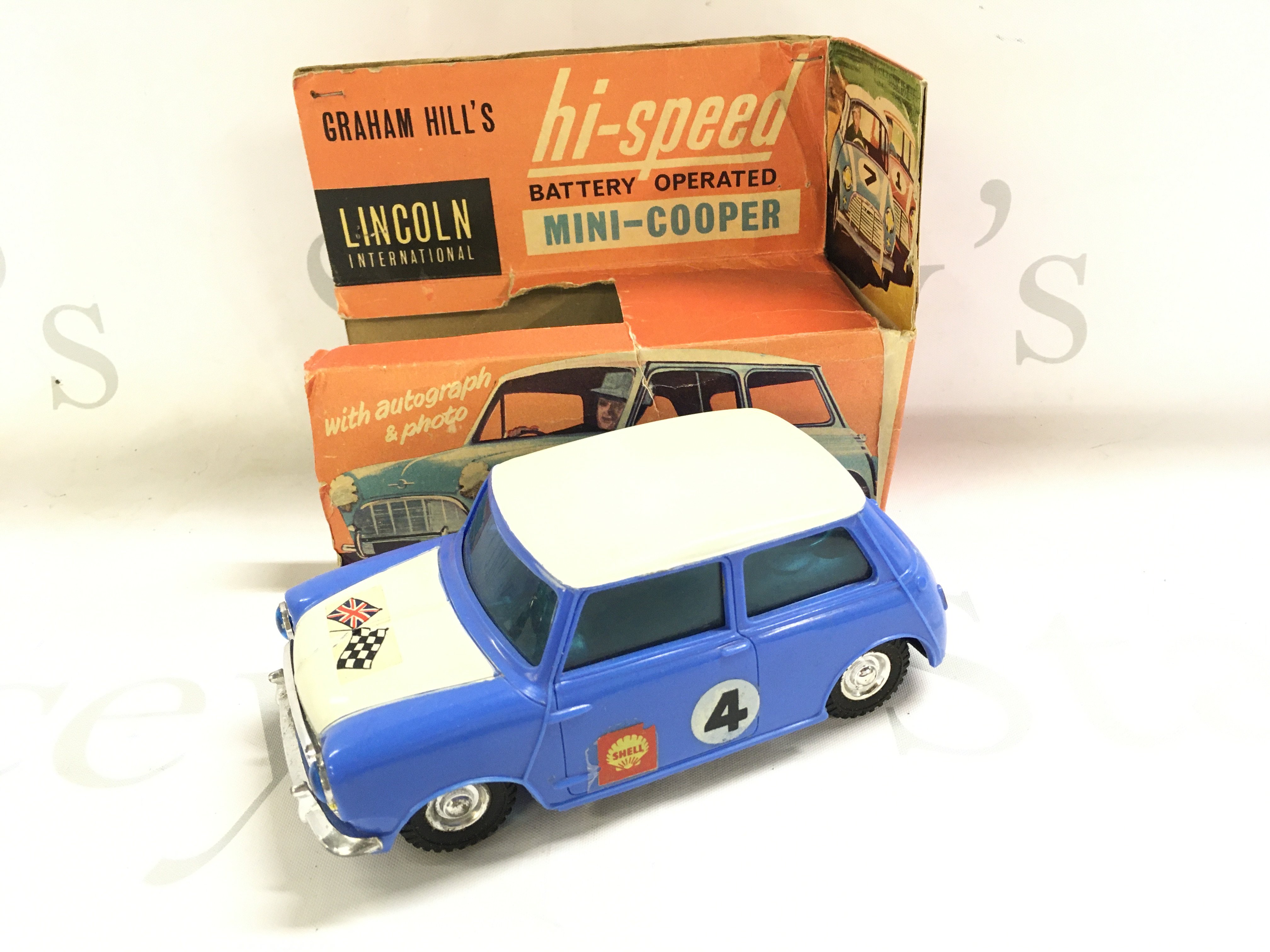 A Boxed Lincoln International Graham Hills Battery Operated Mini-Cooper. Box Is Worn Battery Cover Missing.