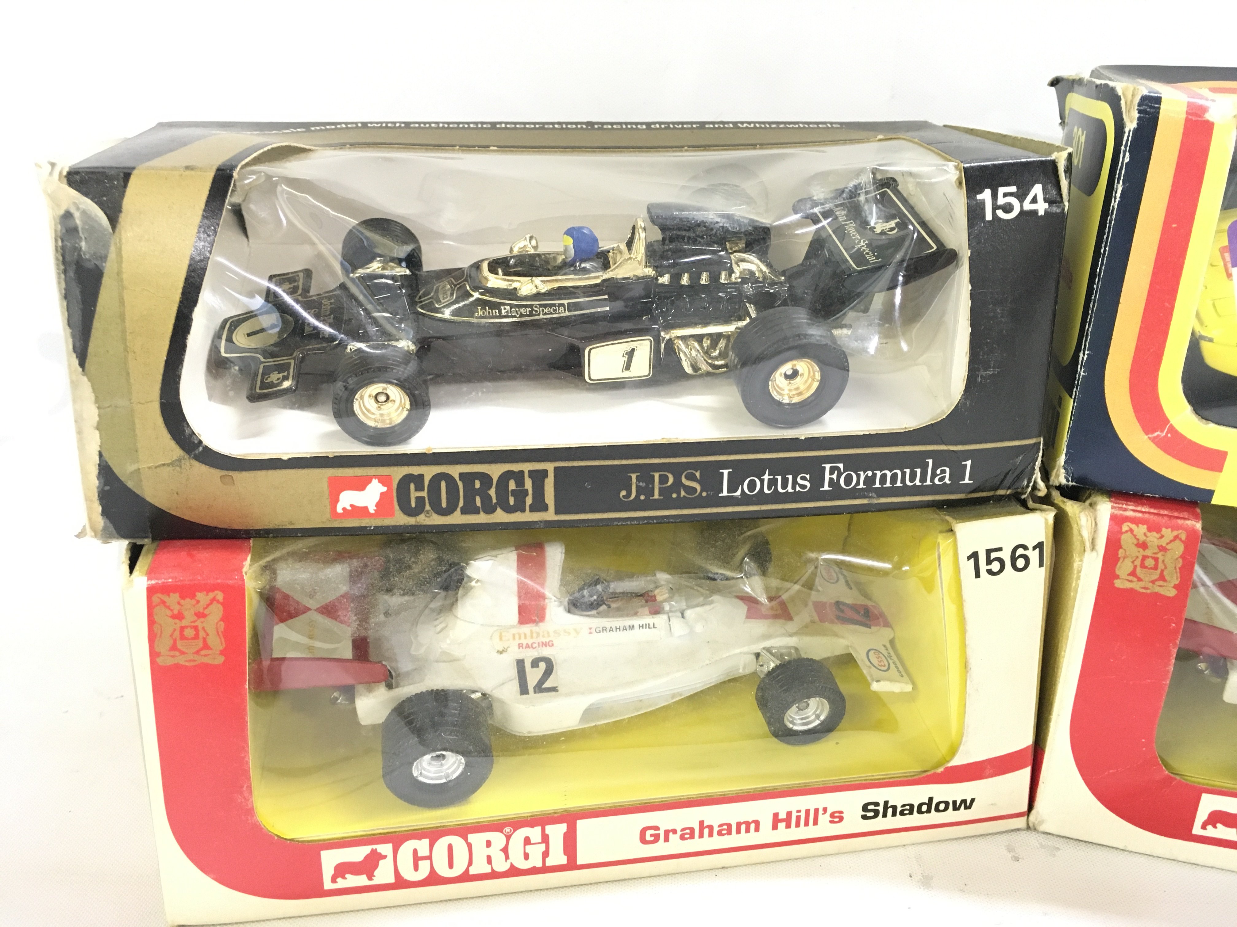 4 Boxed Corgi Lotus Cars. including 2 X Versions of Graham Hills Shaddow #s 156 And 1561. A J.P.S. lotus Formula 1 #154 And A Lotus Elite.