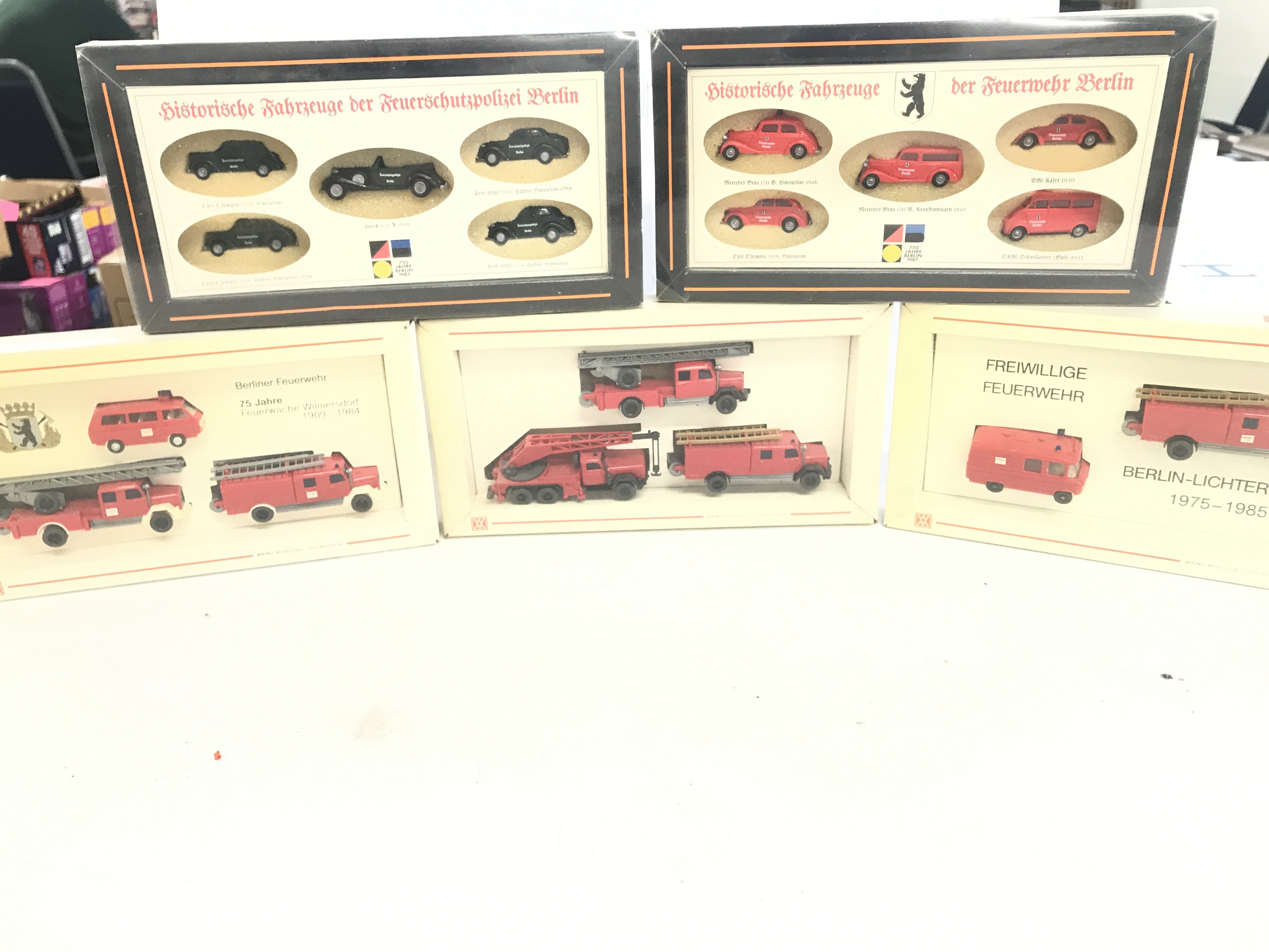 A box containing a collection of model fire engines.