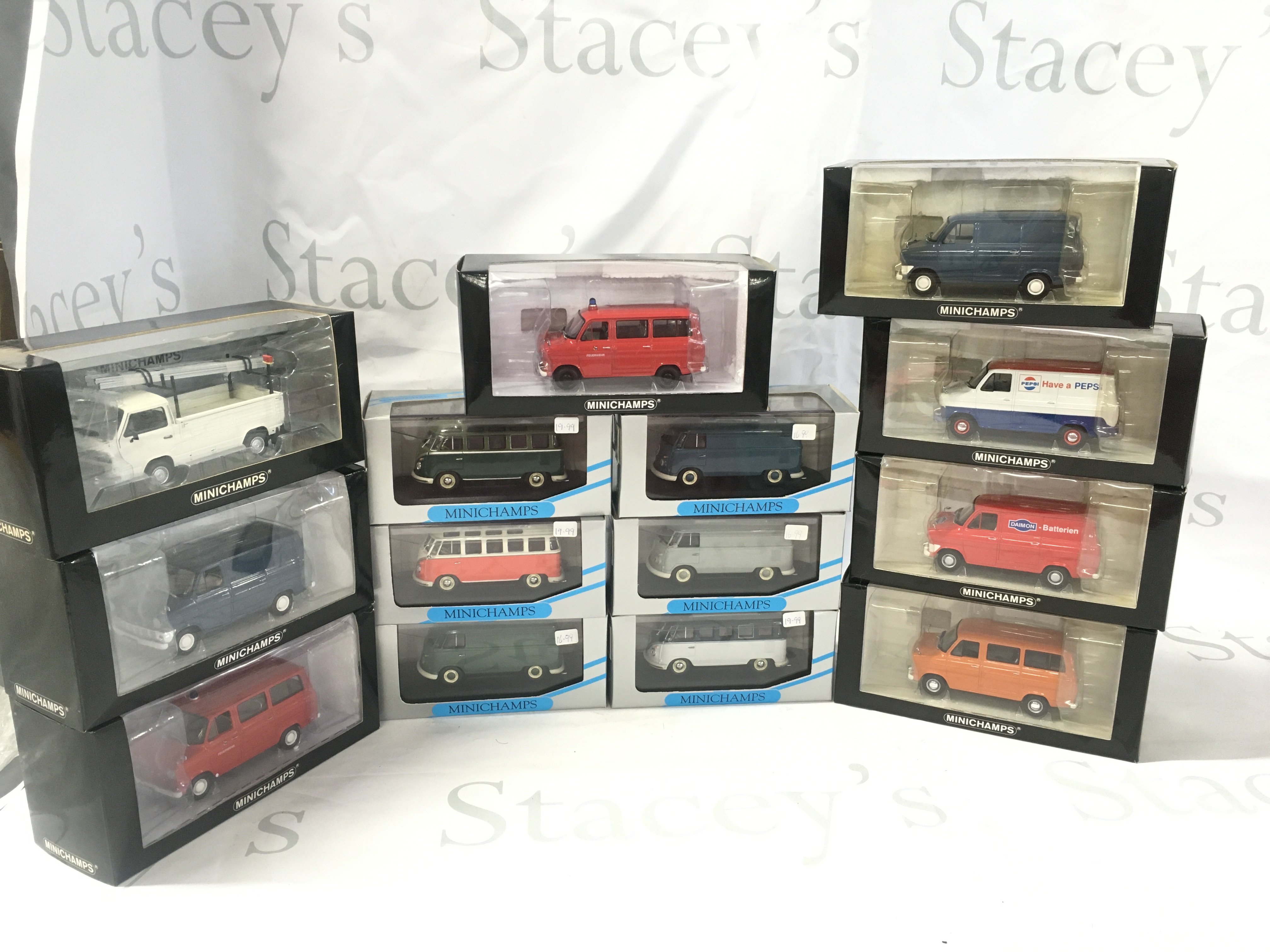 A collection of boxed diecast model vehicles comprising Ford Transit vans and Volkswagen camper vans and truck. No reserve