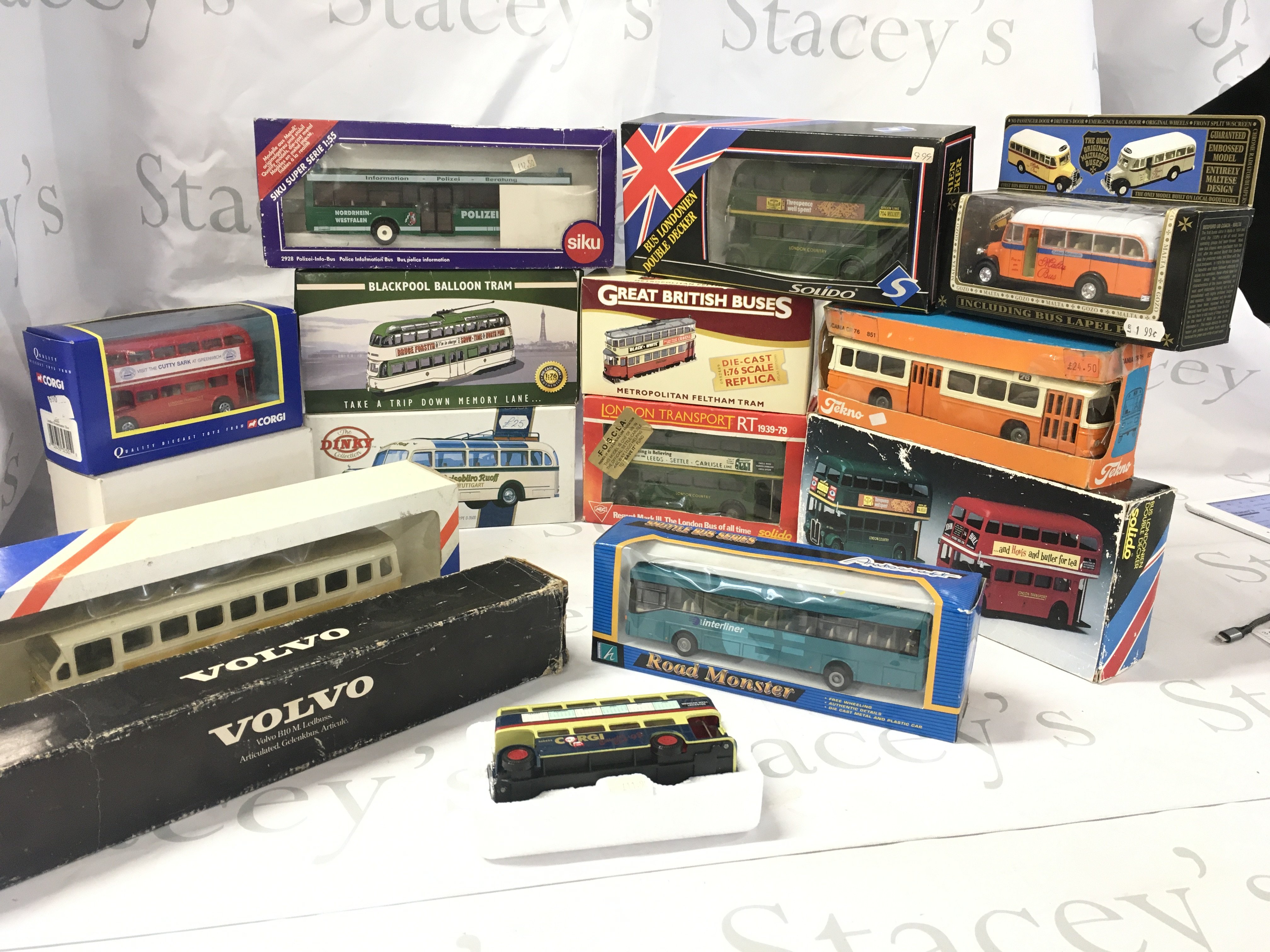 A collection of boxed diecast buses and trams by a variety of manufacturers including Corgi..Dinky ..Solido etc. No reserve