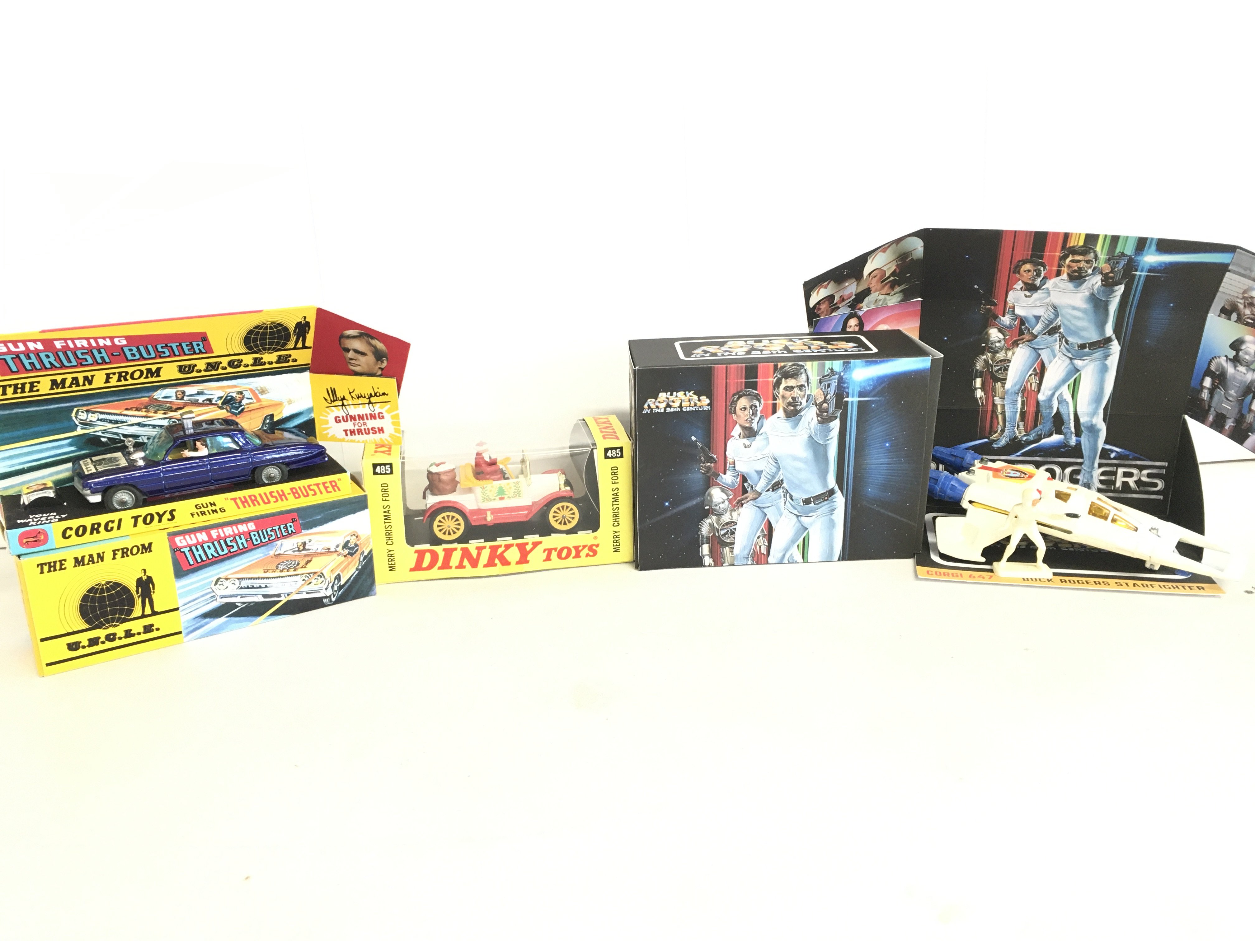 A Corgi Thrush Buster #497. A Dinky Merry Christmas Ford And A Corgi Buck Rogers Star Fighter With Figure In Repro Boxes.
