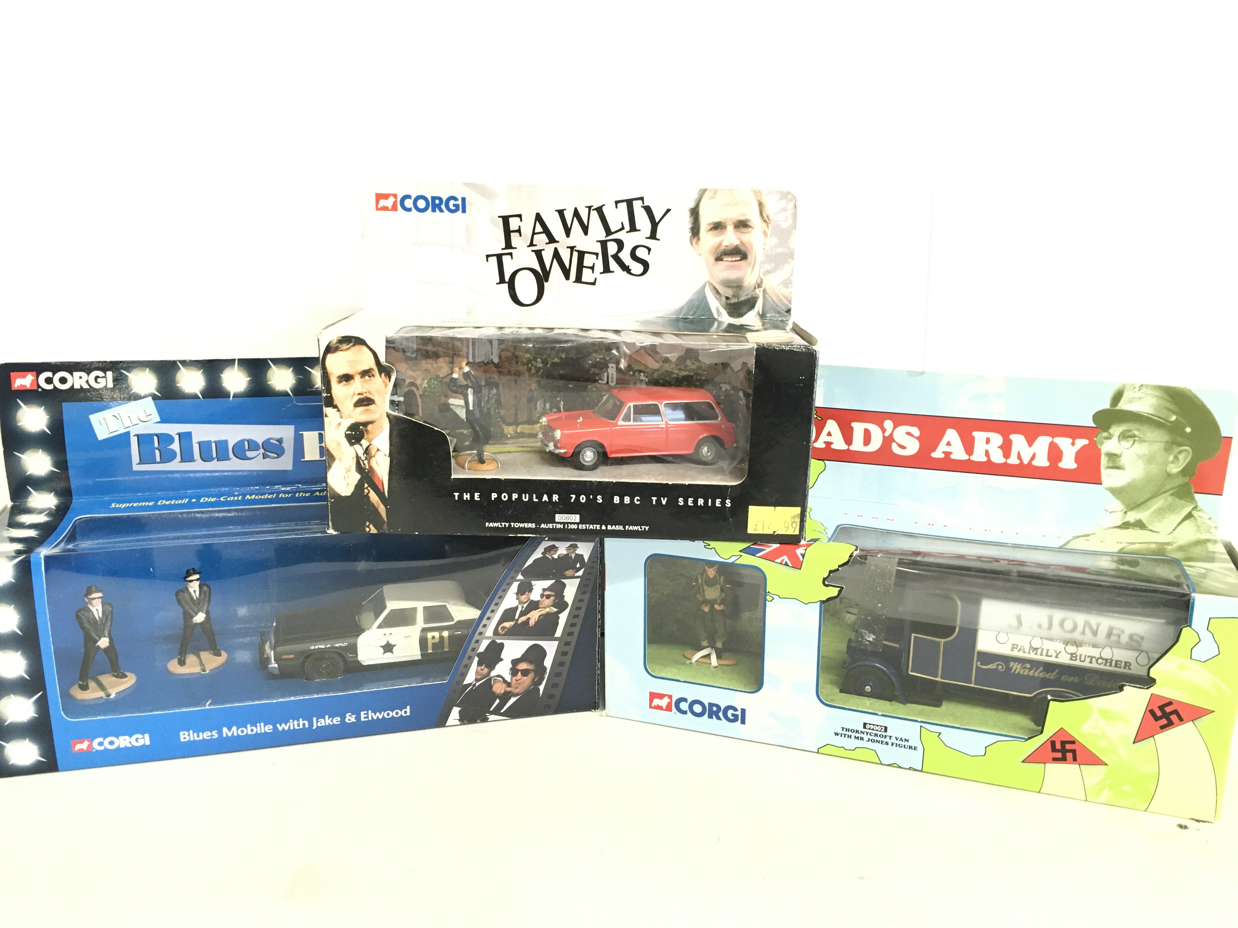 A Boxed Corgi Blues Brothers Mobile. A Dads Army Butcher Van And A Fawlty Towers Austin 1300 Estate.