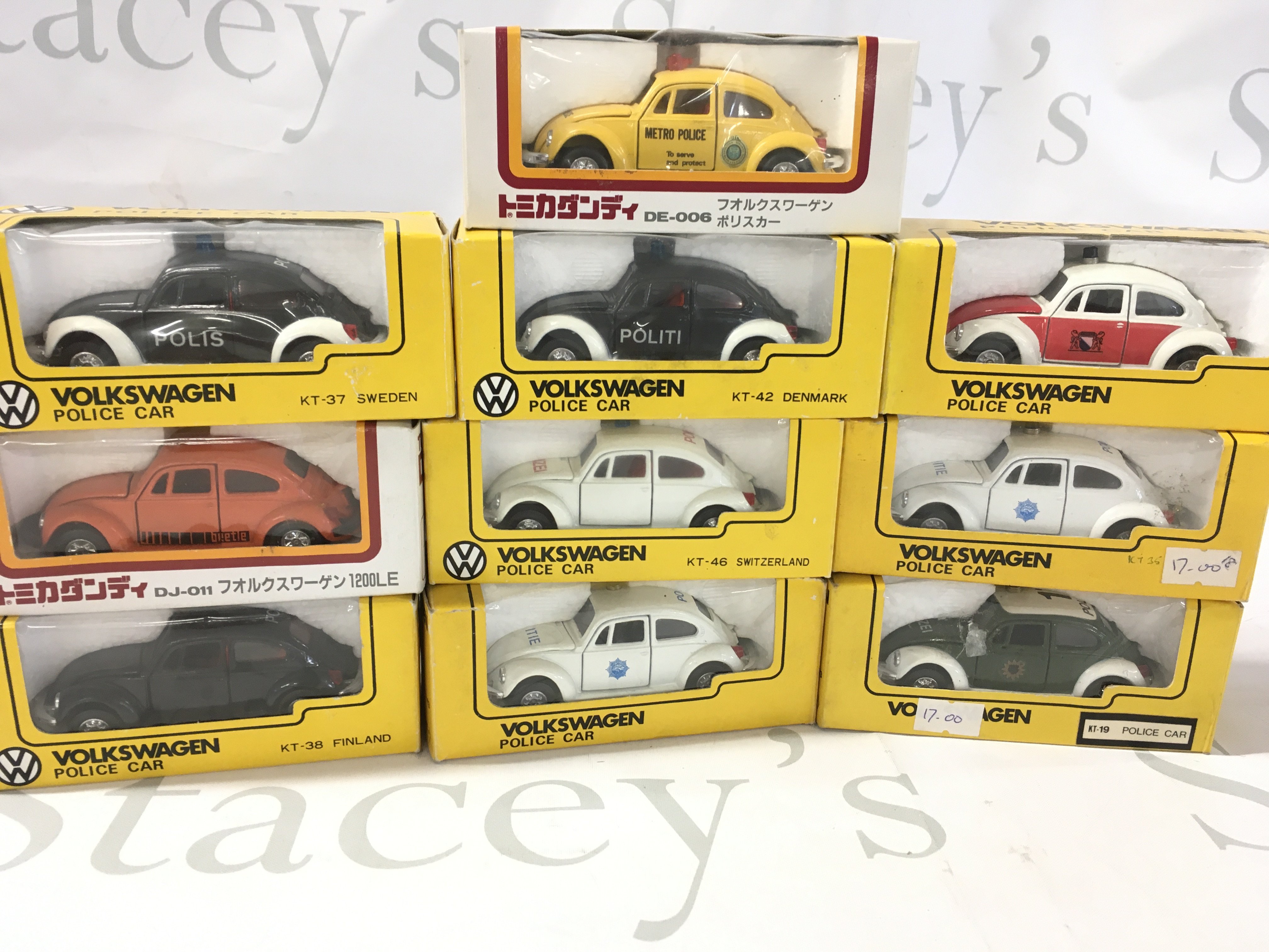 A collection of 10 boxed diecast model Volkswagen Beetle cars each done in police livery from numerous countries. Manufactured by Tomica etc. no reserve