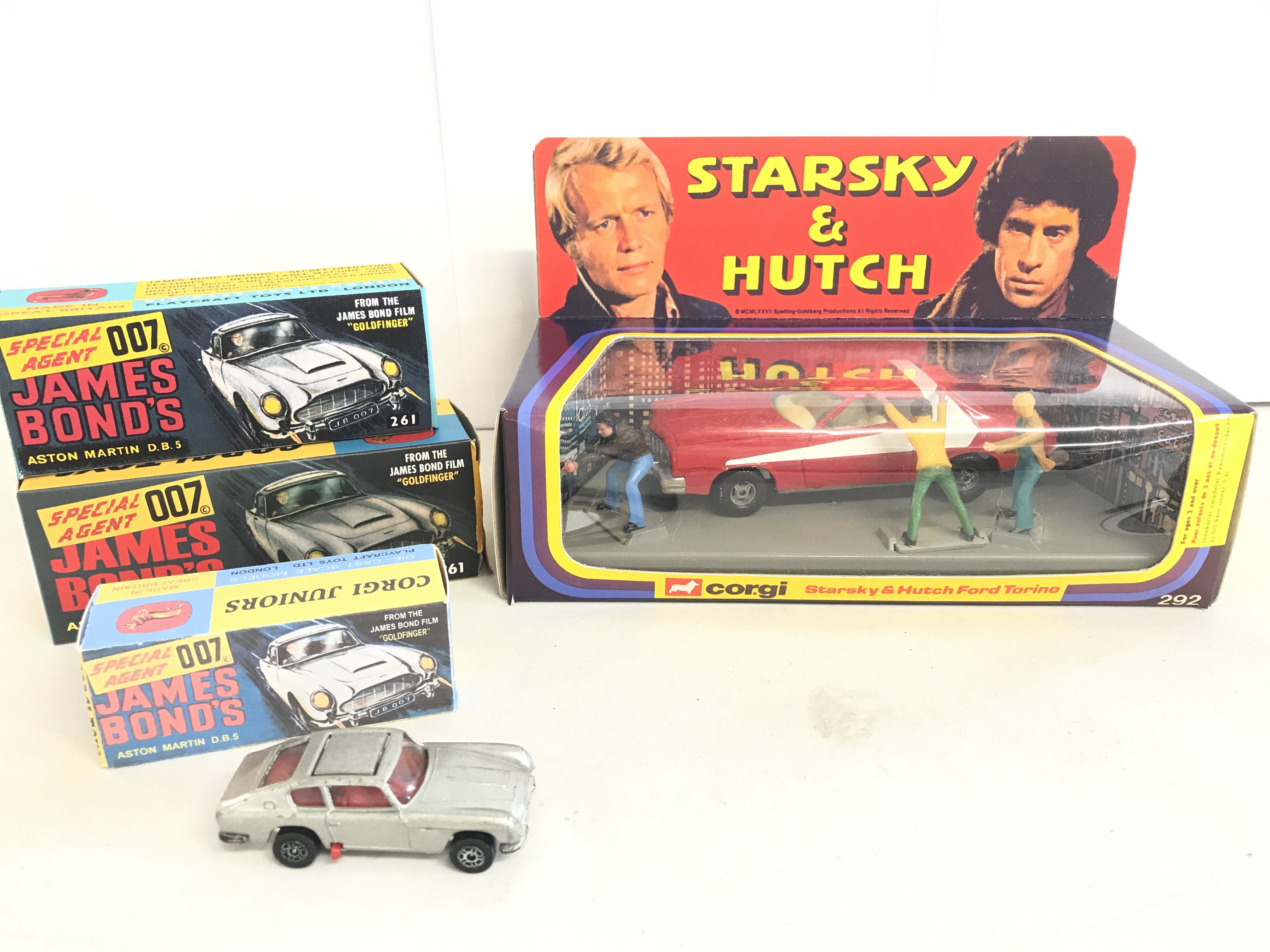 A Corgi Model Club James Bond Aston Martin DB5 #261. A Starsky And Hutch Ford Torino #202 in Repro Box. And 2 Other Bond Cars In Repro Boxes.