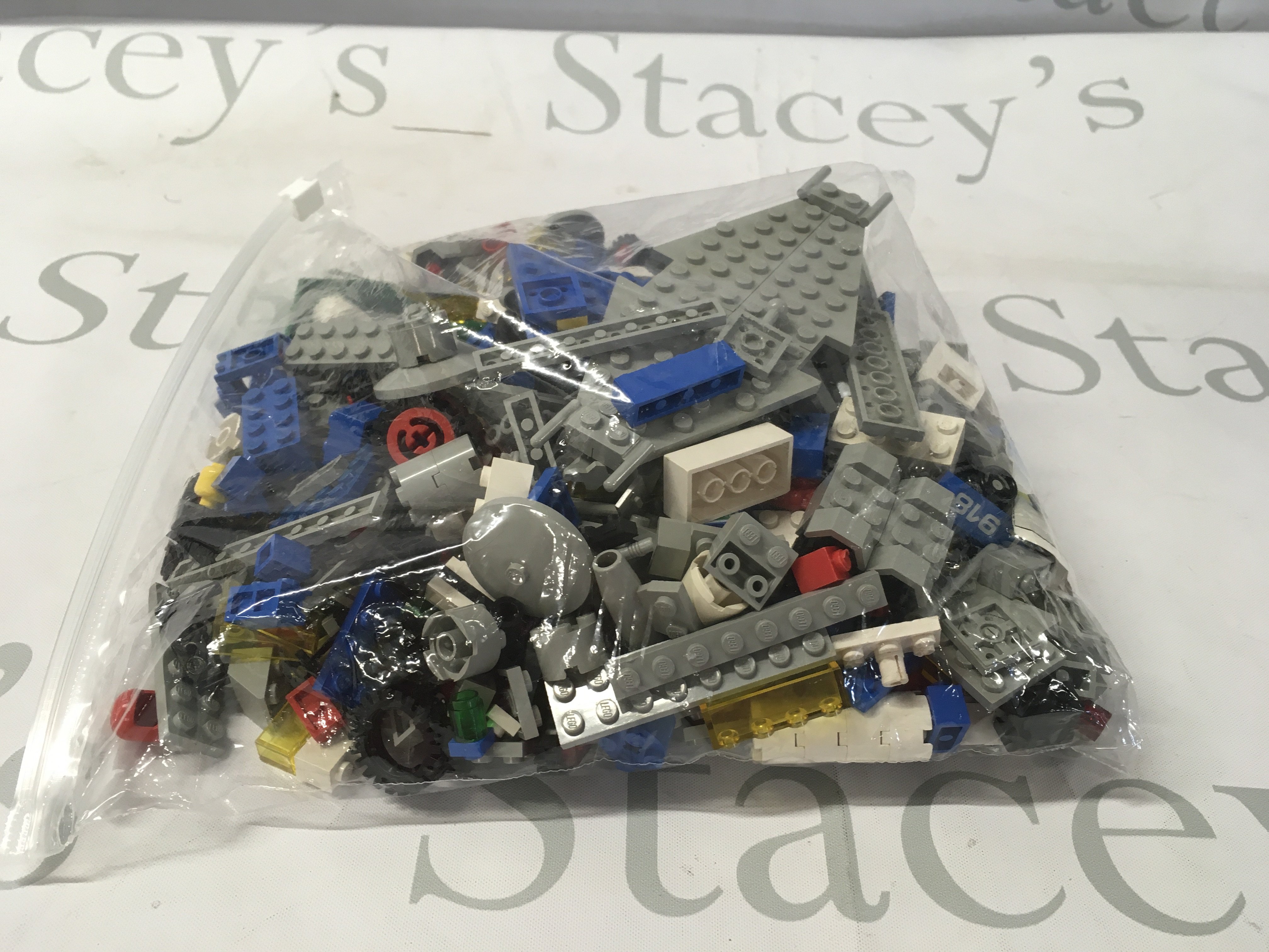 A bag containing an assortment of loose Lego building pieces. No reserve
