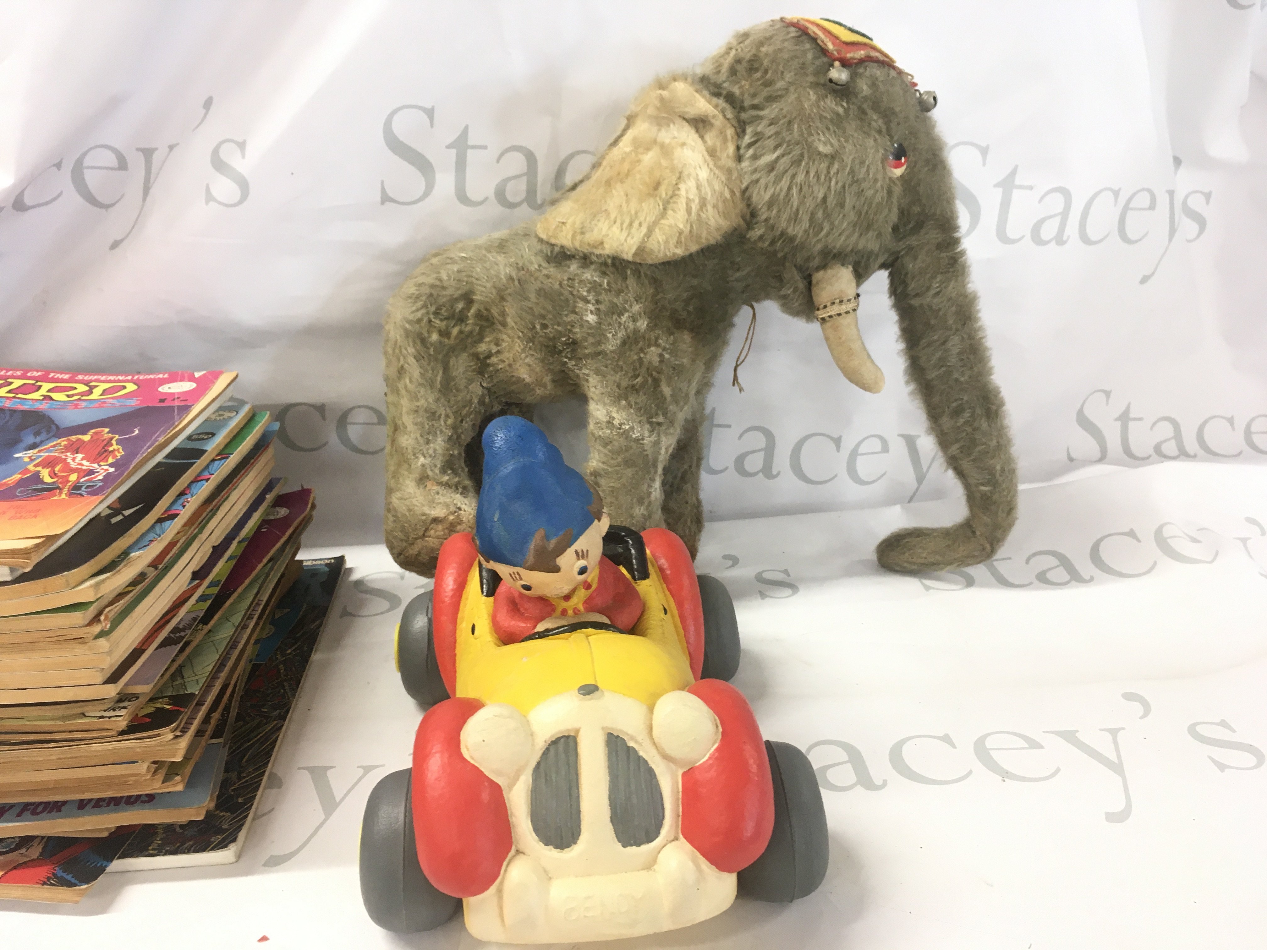 A box containing a vintage toy circus elephant..a Bendy Noddy Car and several hundred comics with titles including Starblazer..Tornado..Judge Dredd plus others including no.1 issues. No reserve.