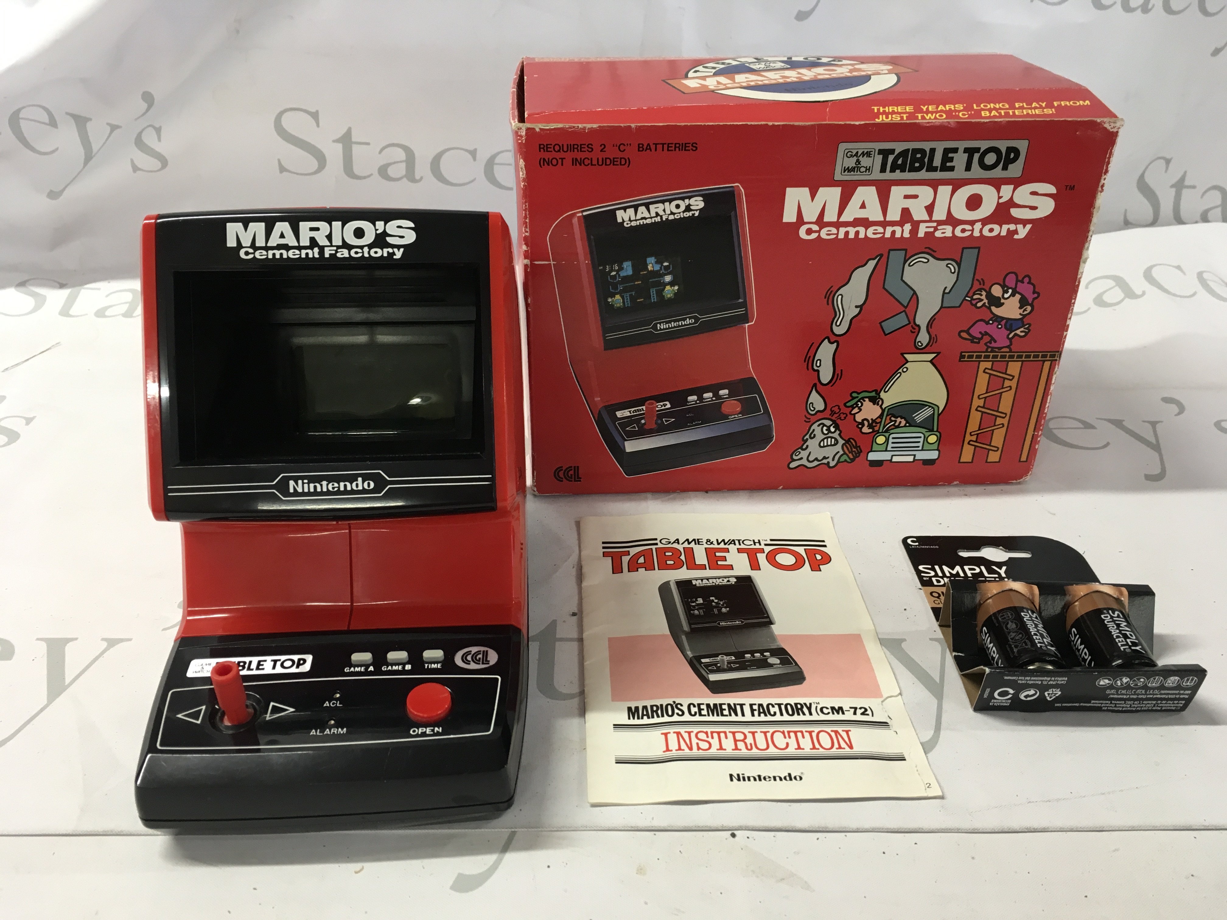 A boxed Table Top Game and Watch&hellip;.Marios Cement Factory in working order. Includes instructions. No reserve