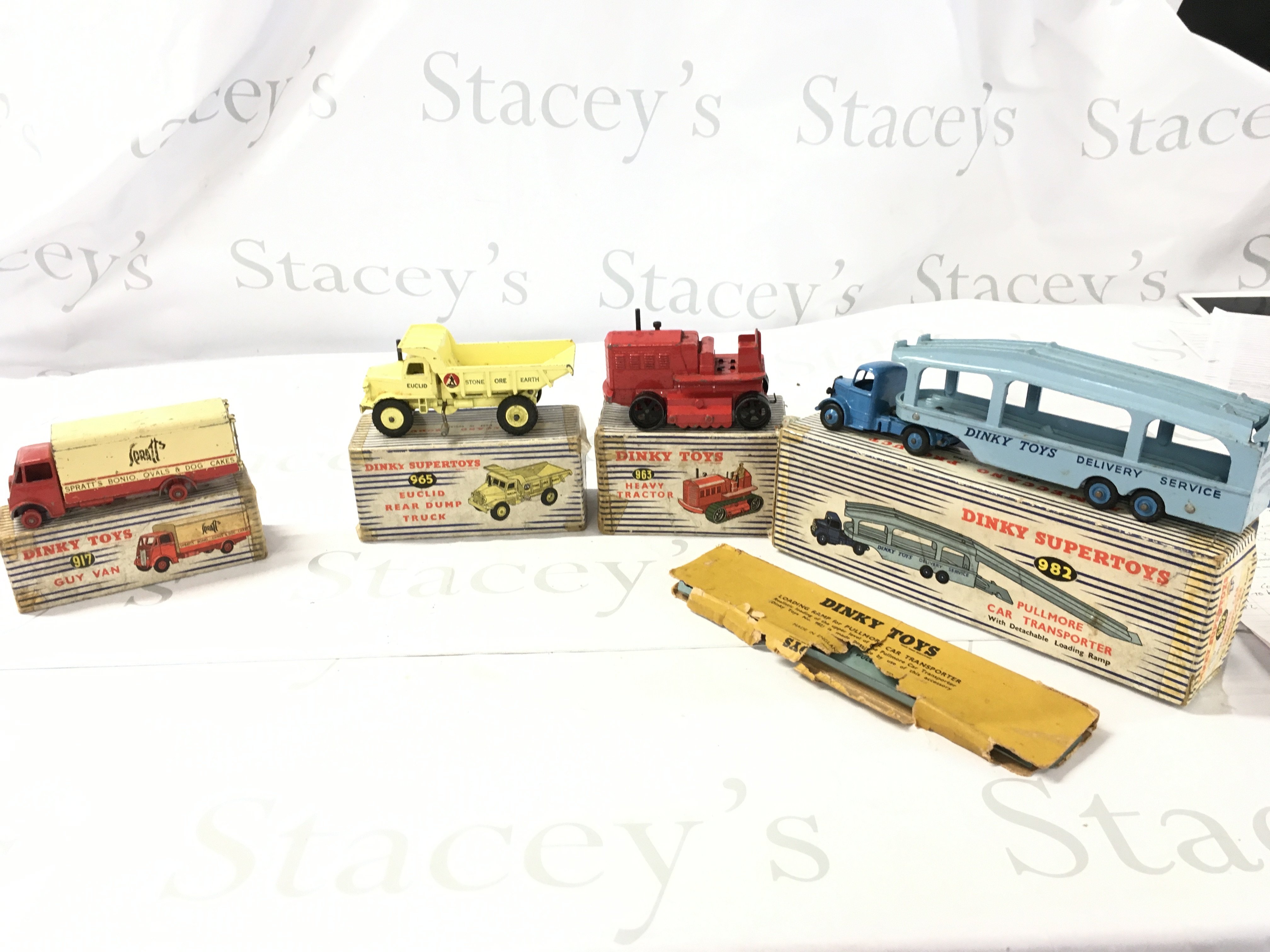 A Collection of 4 vintage boxed Dinky vehicles featuring construction and commercial pieces. Includes 917..963..965..982. Boxes are worn and track on 963 perished. No reserve