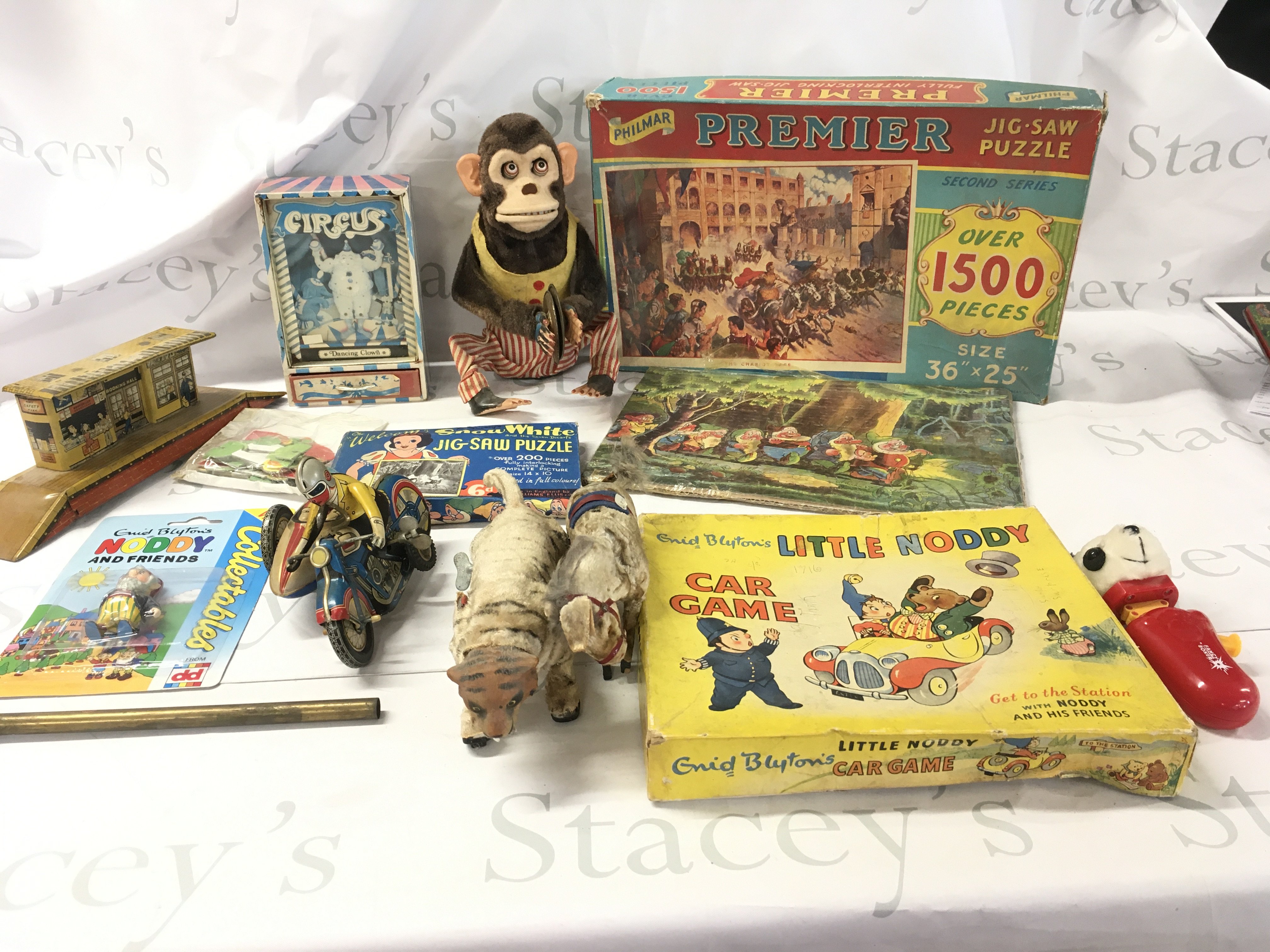 An assorted collection of older toys featuring numerous characters including Snow White..Noddy etc. includes jigsaws..clockwork toys etc. no reserve