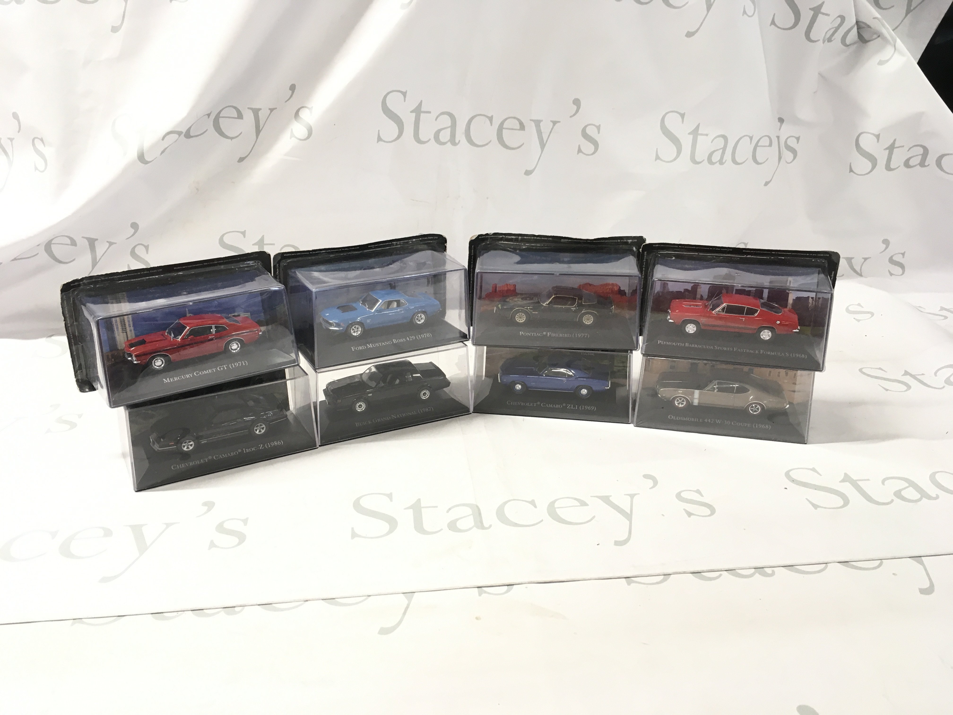 A collection of mostly unopened boxed diecast model cars by various manufacturers featuring American cars. No reserve