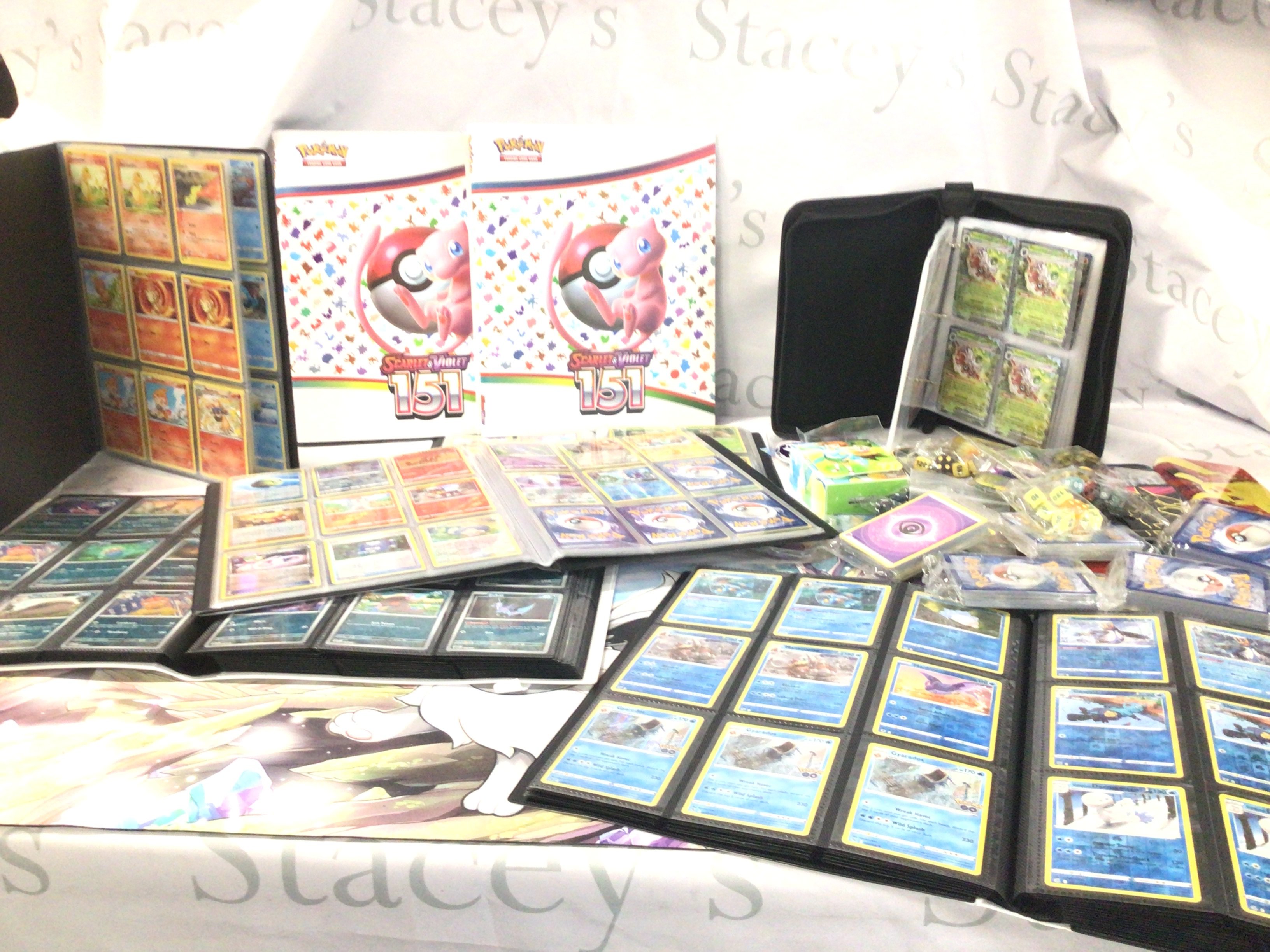 A large collection of modern Pok&eacute;mon cards many in albums or in sealed packs includes dice etc.