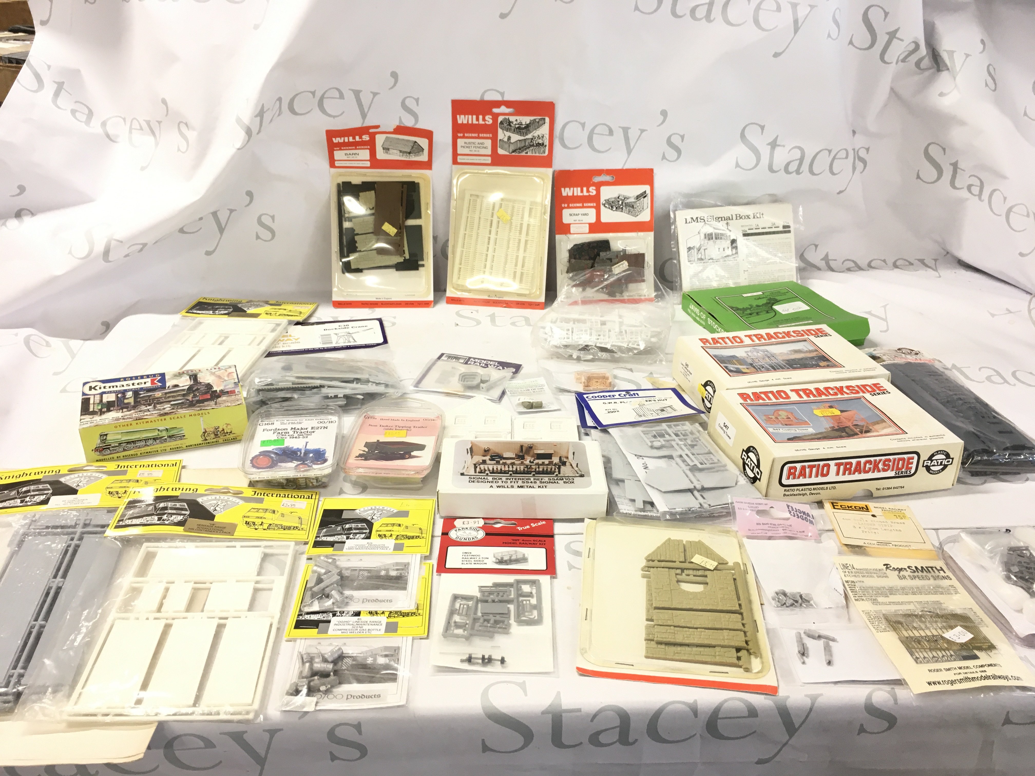 A collection of model railway accessories mostly in unopened kit form comprising buildings, vehicles etc. 00 gauge. No reserve