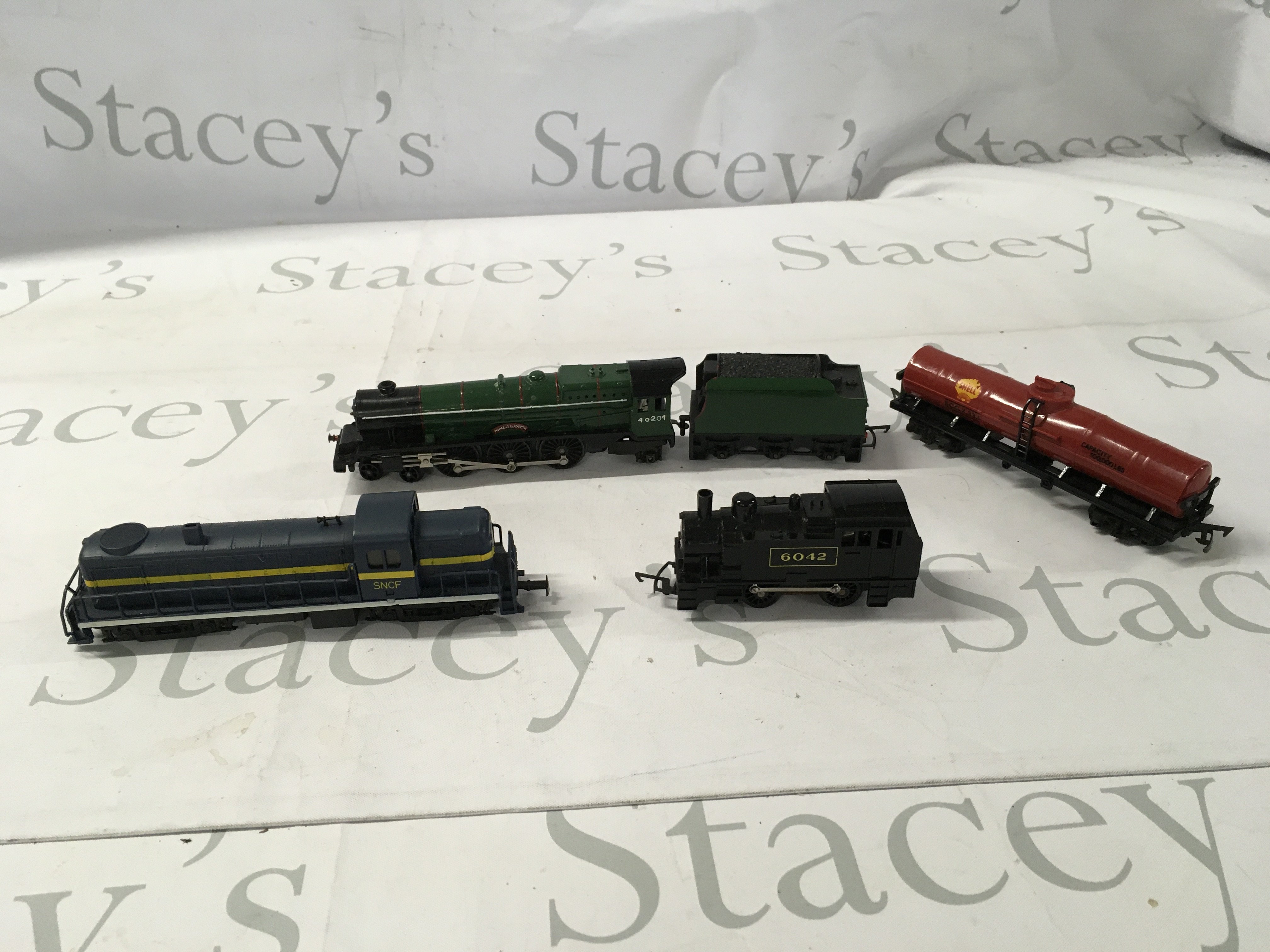 A small collection of 3 model locomotives a tender and a petrol tanker all 00 gauge. Plus a Corgi diecast model locomotive.No reserve