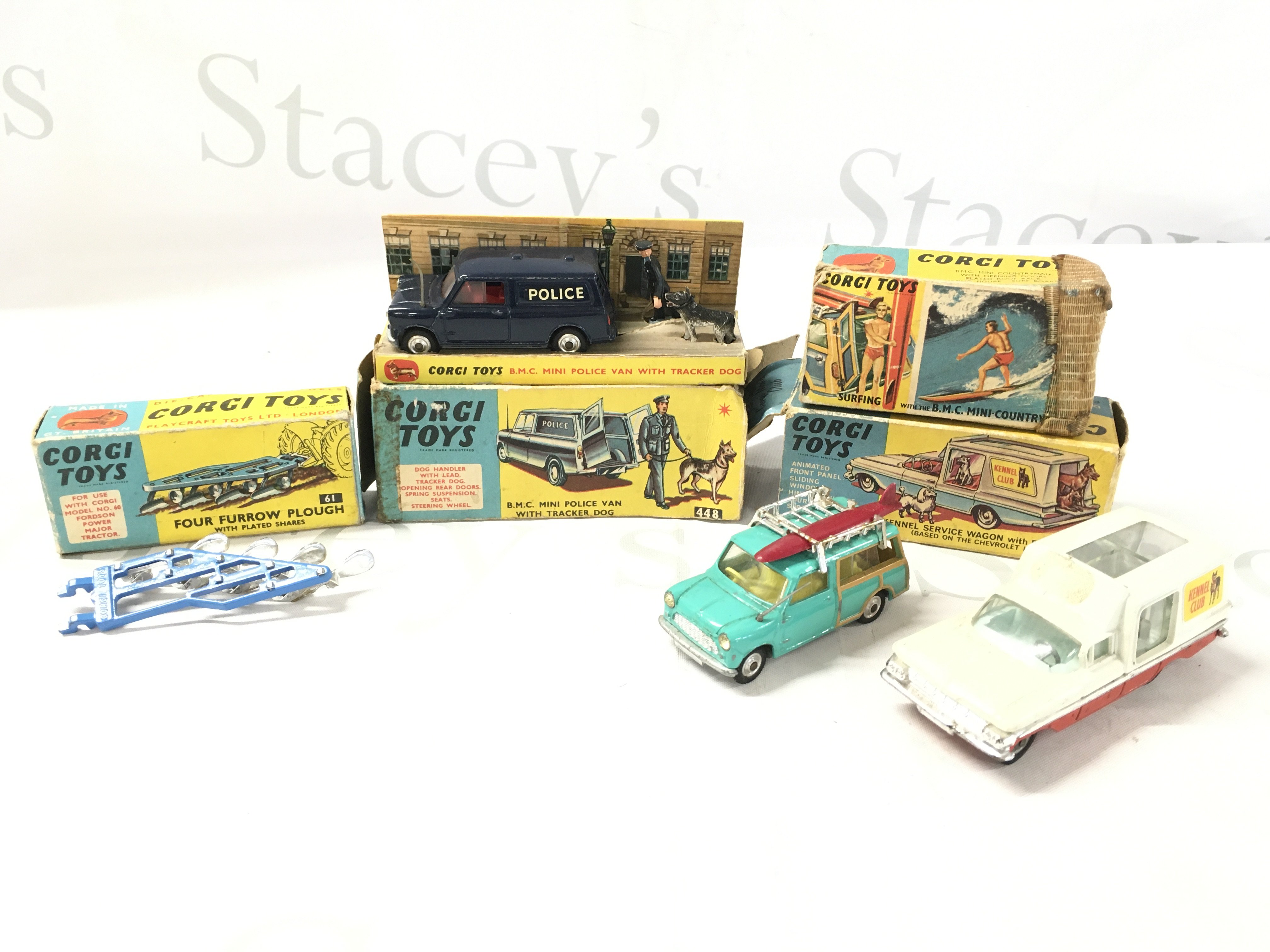 A Collection Of 4 Boxed Corgi Vehicles. A Four Four Plough #61. A B.M.C. Mini Police Van With Tracker Dog #458 (lead Broken) A Surfing B.M.C. Mini Countryman #485 And A Kennel Service Wagon #486. All Boxes Are Worn Etc.
