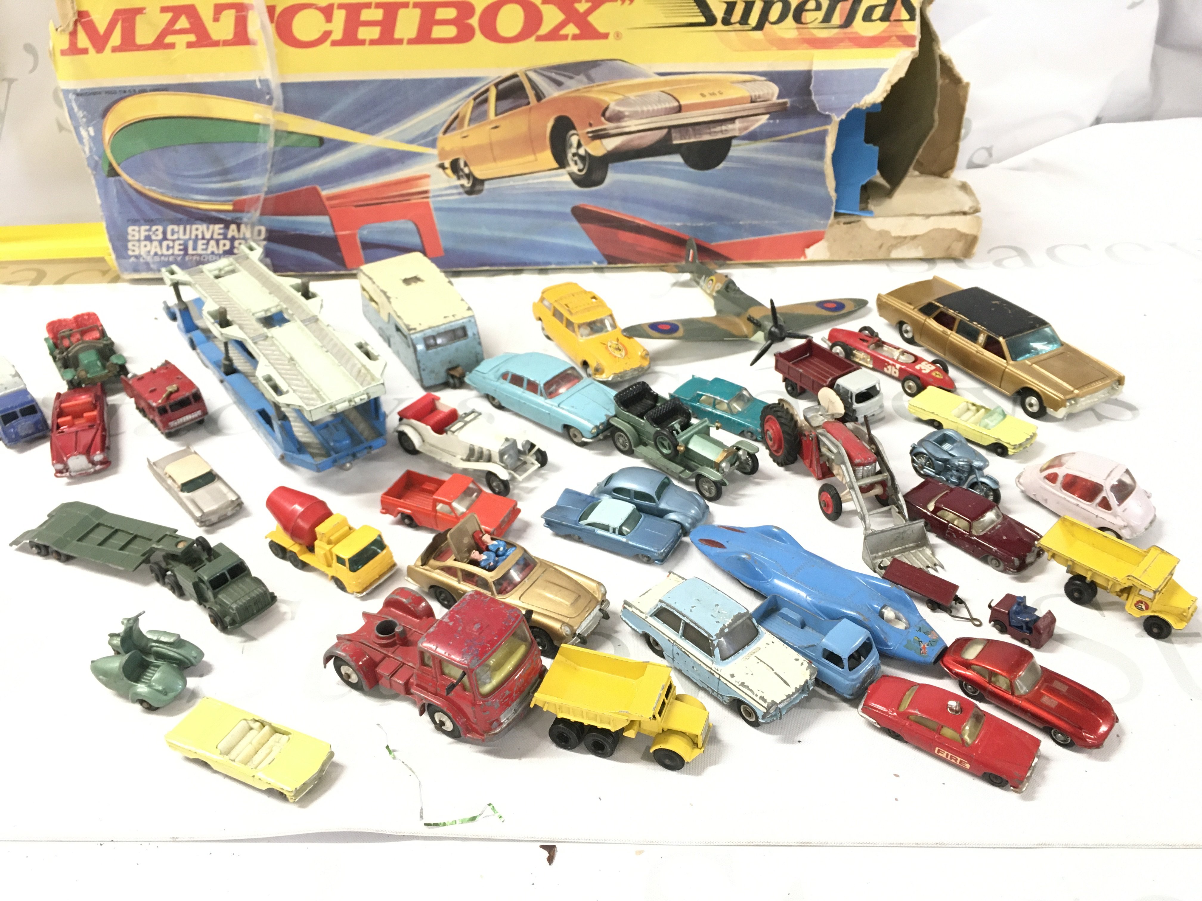A Collection Of Playworn Diecast including Matchbox. Corgi And Dinky. A Matchbox SF-3 Curve And Space Leap Set. And A Marx Tinplate Racing Set. No Reserve.