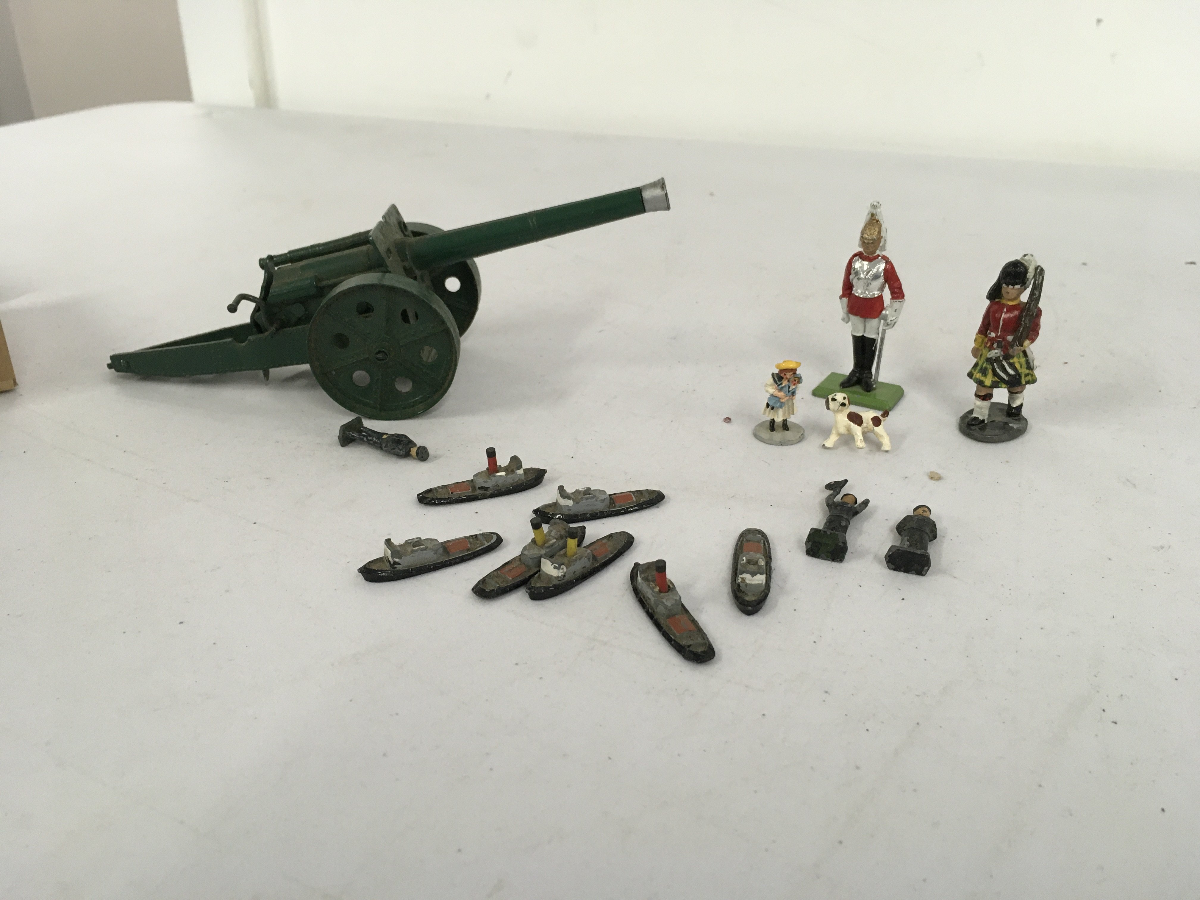 A artillery model gun by Britains and other figures by Crescent and others. No reserve