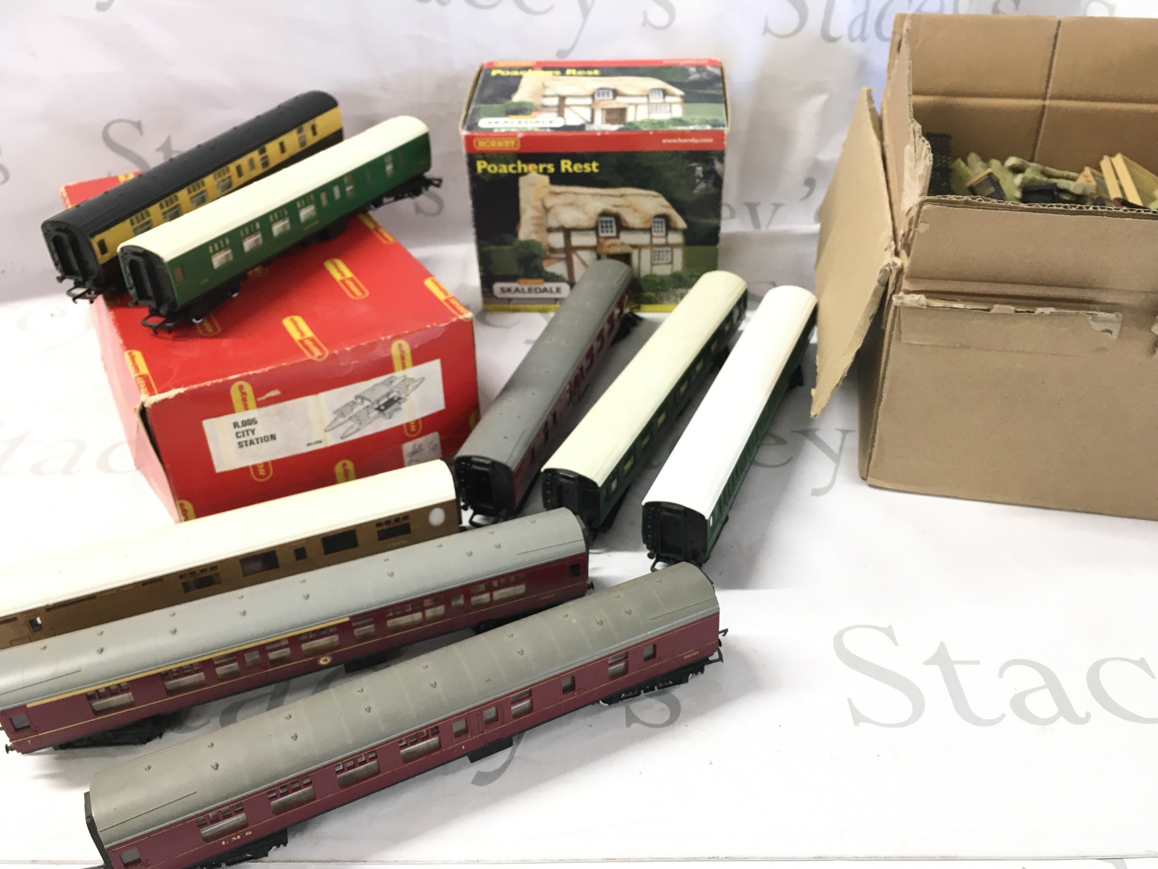 A Collection Of 00 Gauge Coaches. A Boxed City Station. A Boxed Poachers Rest. And May Other Accessories.