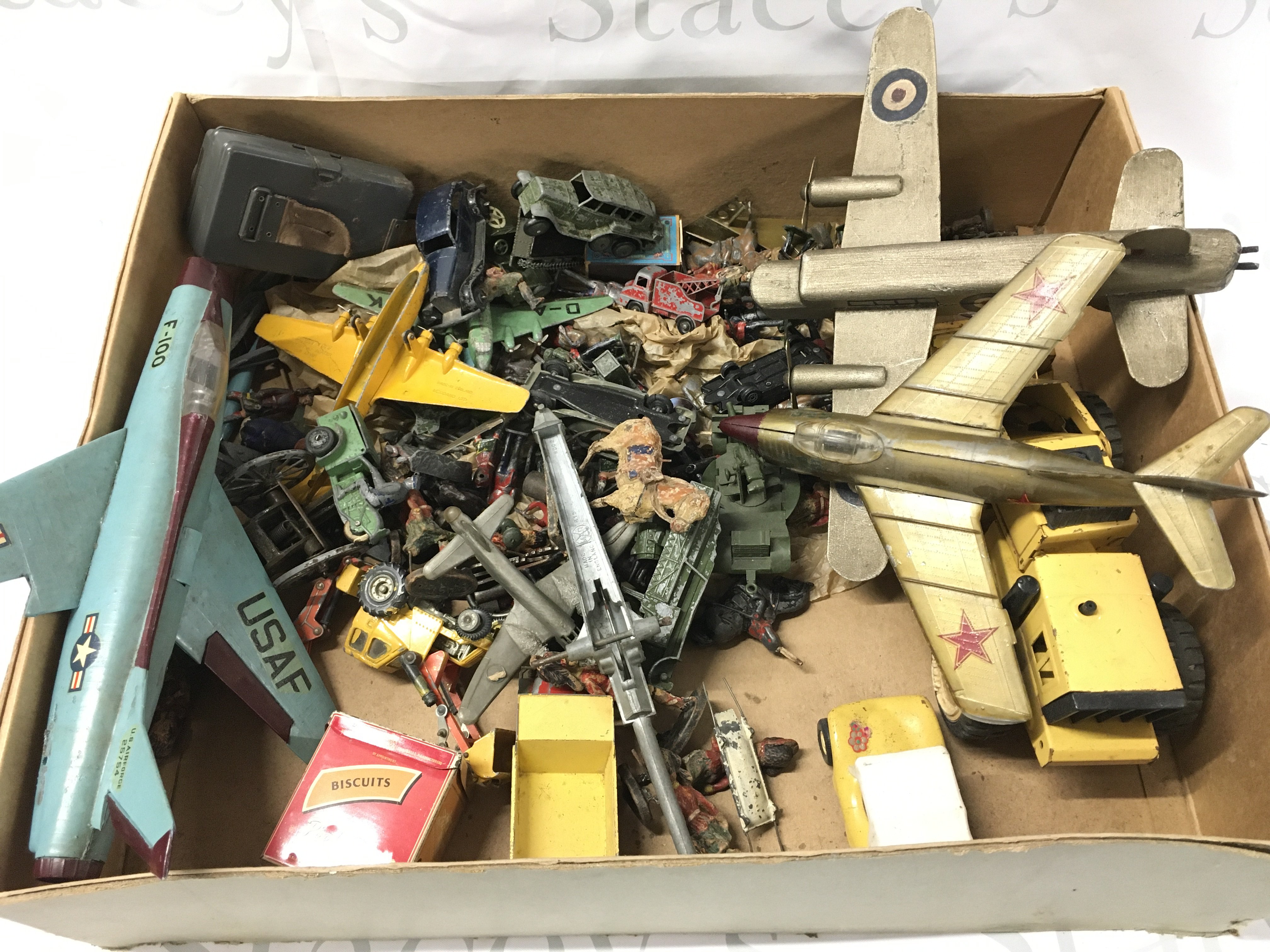 A Box Containing Playworn Toys Including Soldiers. And Aircraft. No Reserve.