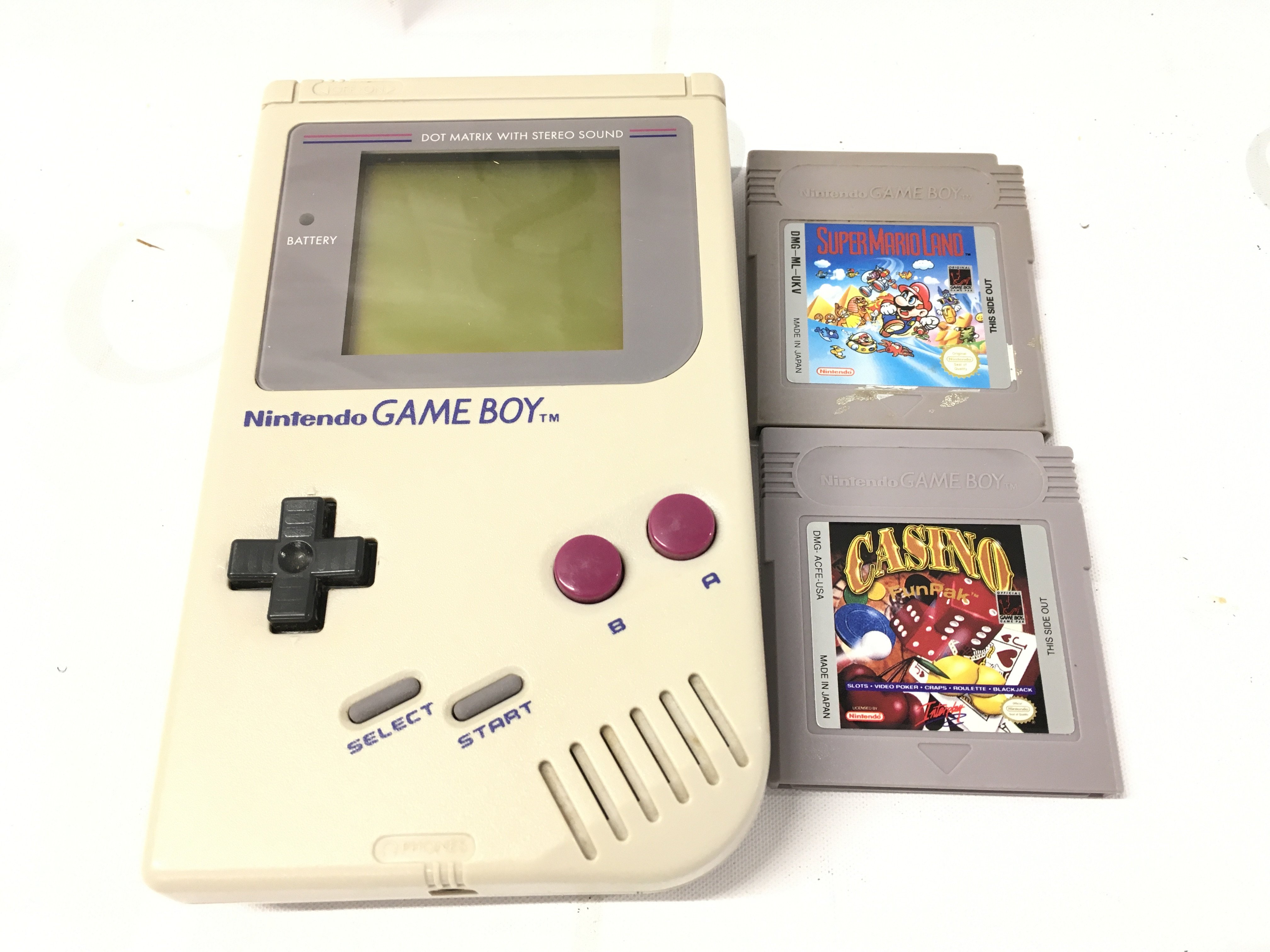 A Nintendo Gameboy With Two Games.