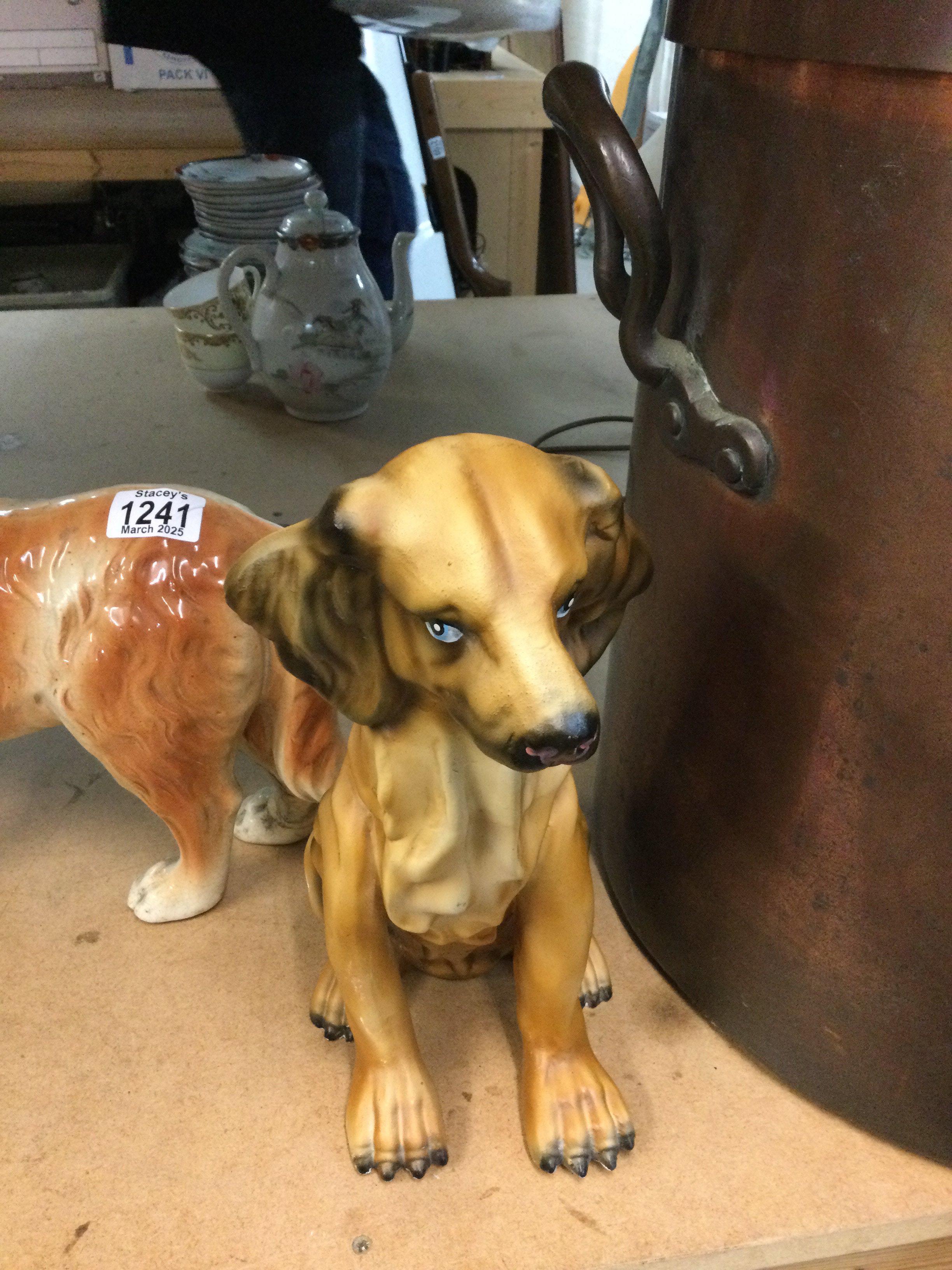 A pair of Staffordshire dogs and one other ceramic dog.