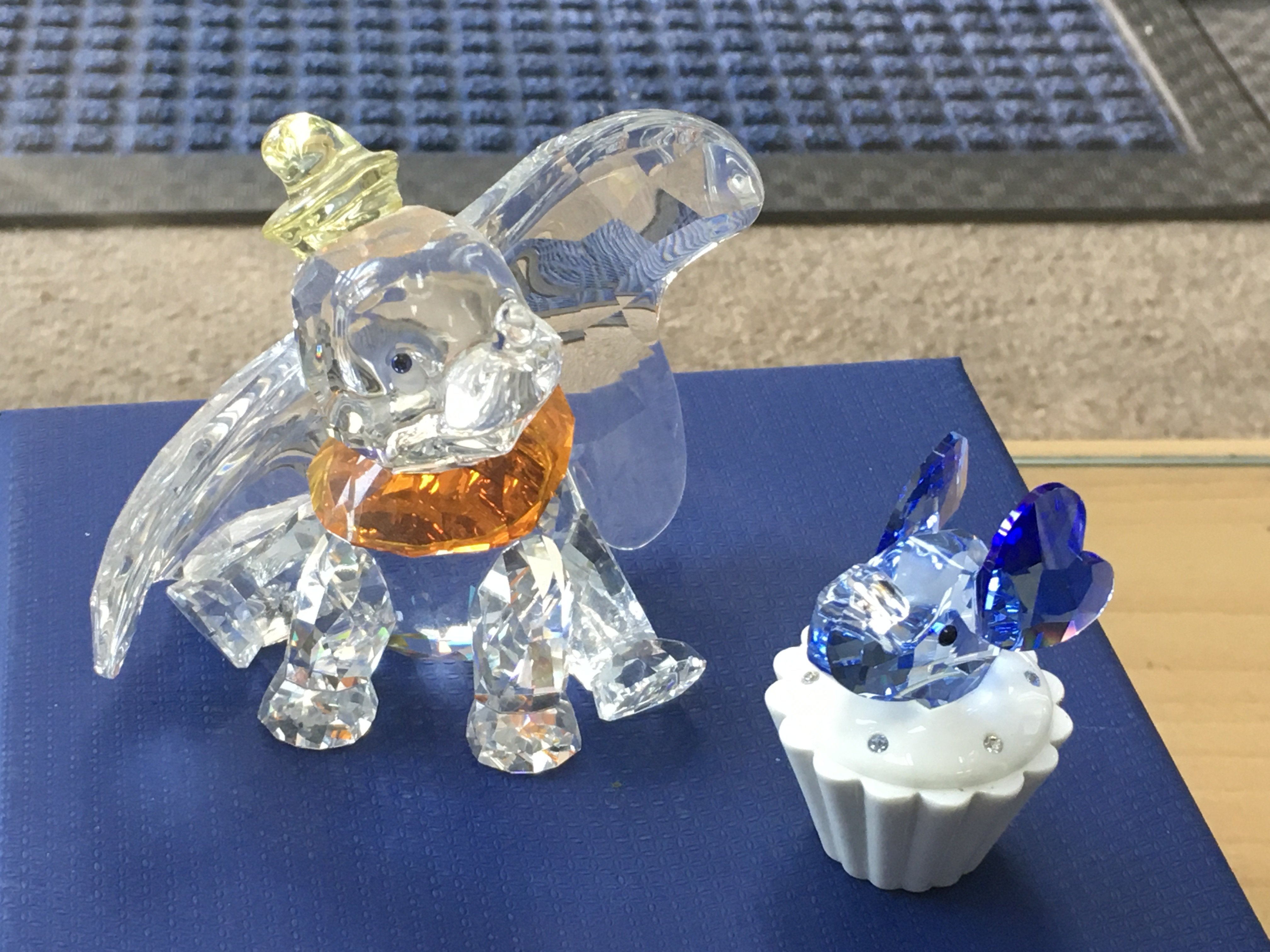 A Boxed Swarovski Disney figure of Dumbo, together with a trinket box with an blue coloured elephant head on the lid