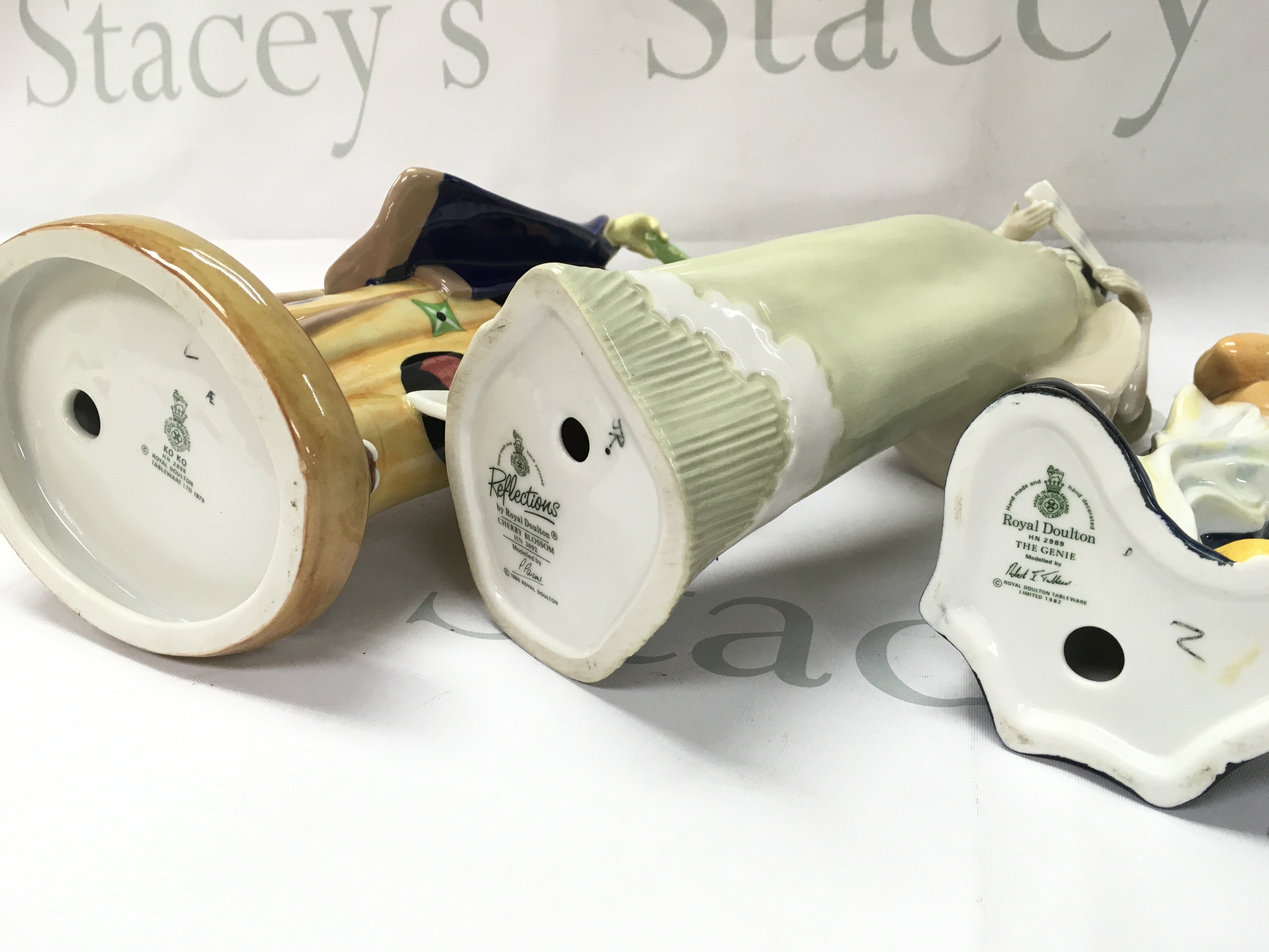 Royal Doulton porcelain figures The Genie, Reflections Cherry Blossom, Ko Ko. No obvious damage or restoration This lot cannot be posted