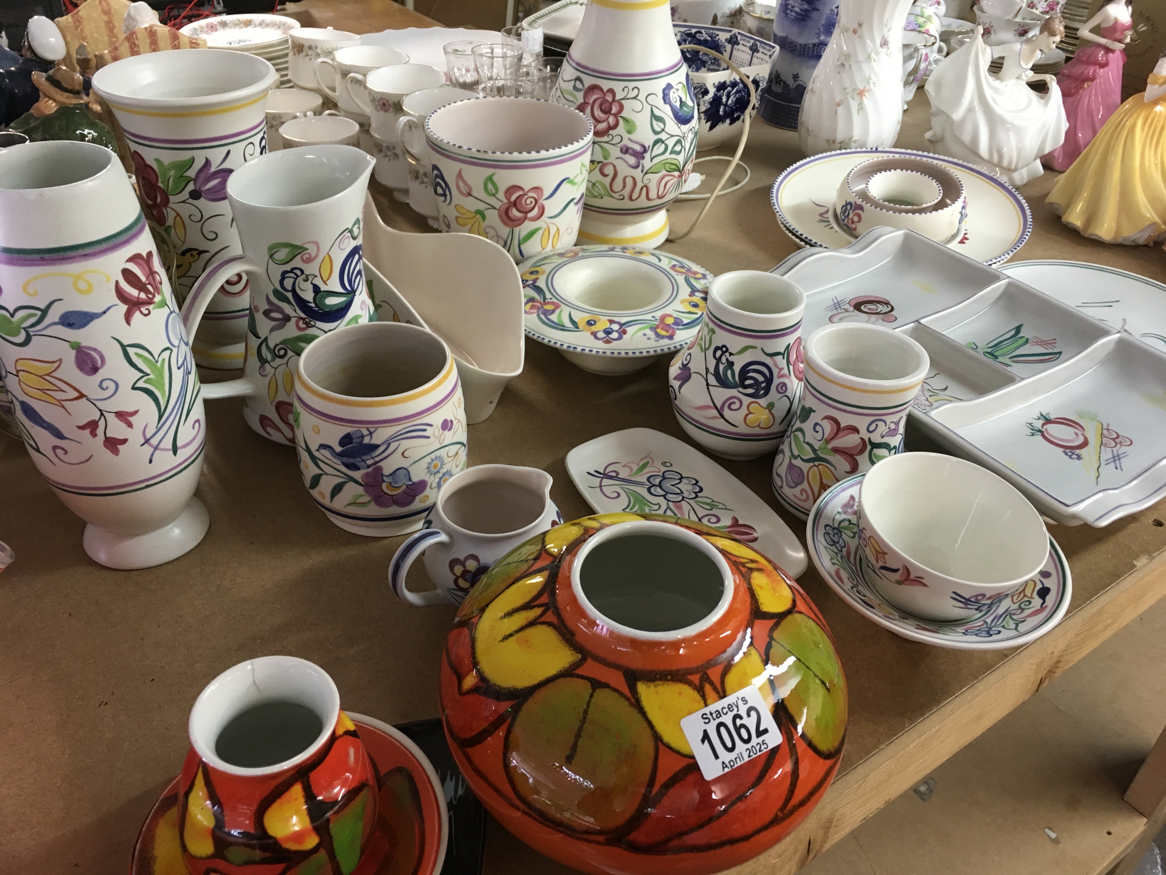 A collection of Poole pottery including lamp vases jugs vases and dishes .