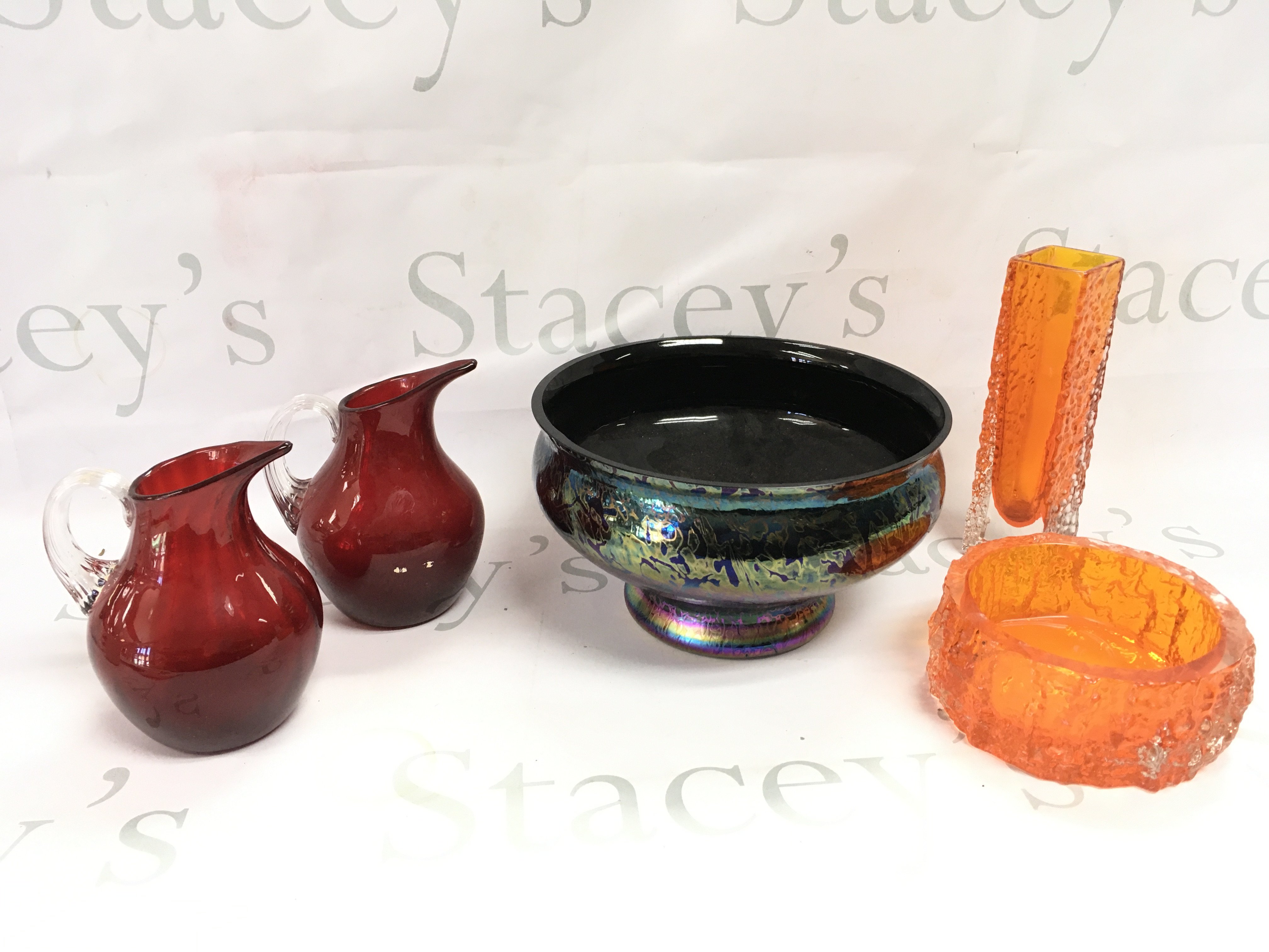 A collection of glassware including a Whitefriars bark vase and bowl , 20th century Royal Brierley iridescent studio glass bowl , a pair of small ruby glass pitchers