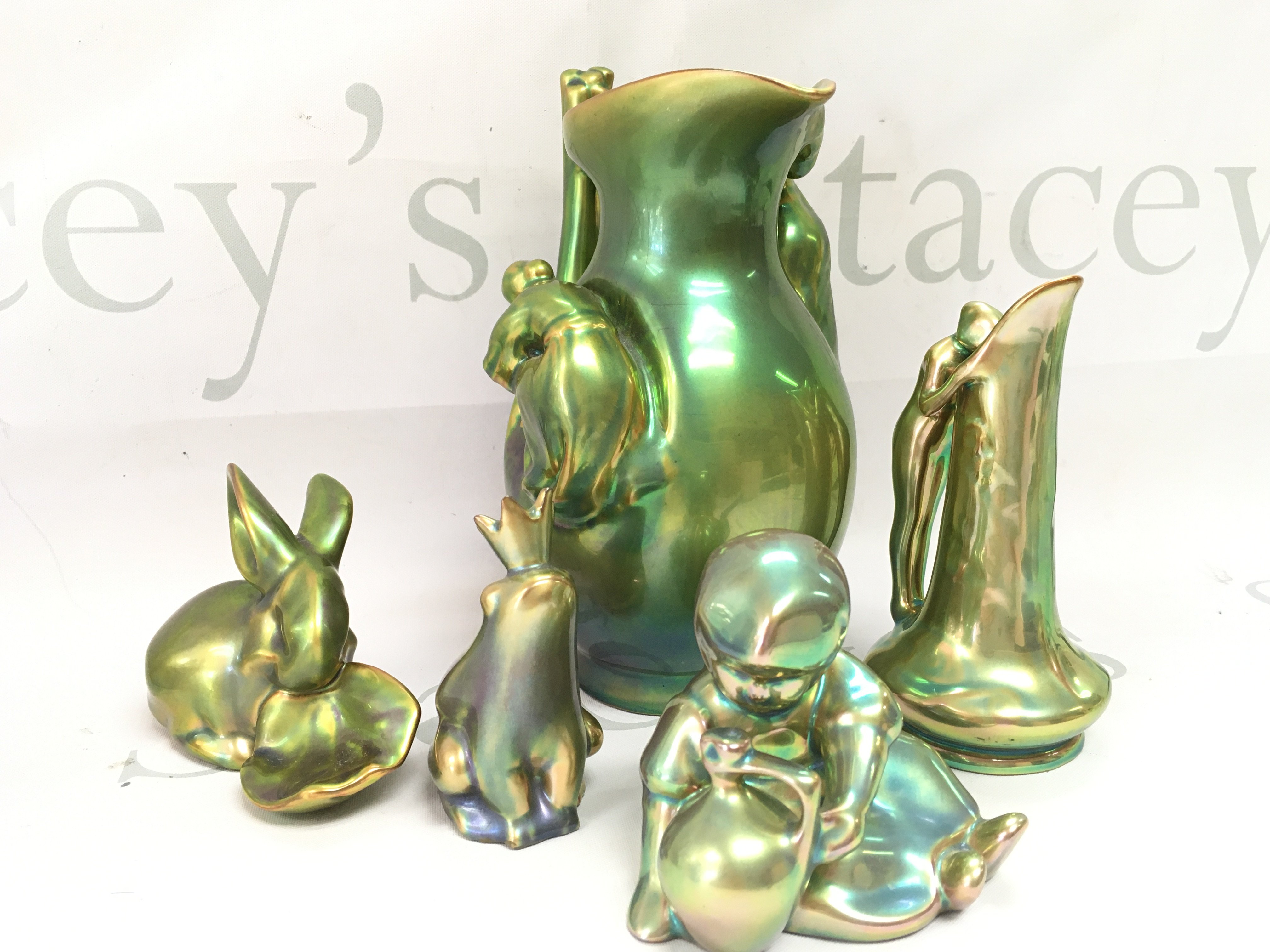 A collection of Zsolnay Pecs lustre glazed pottery Figures and a jug. This lot cannot be posted