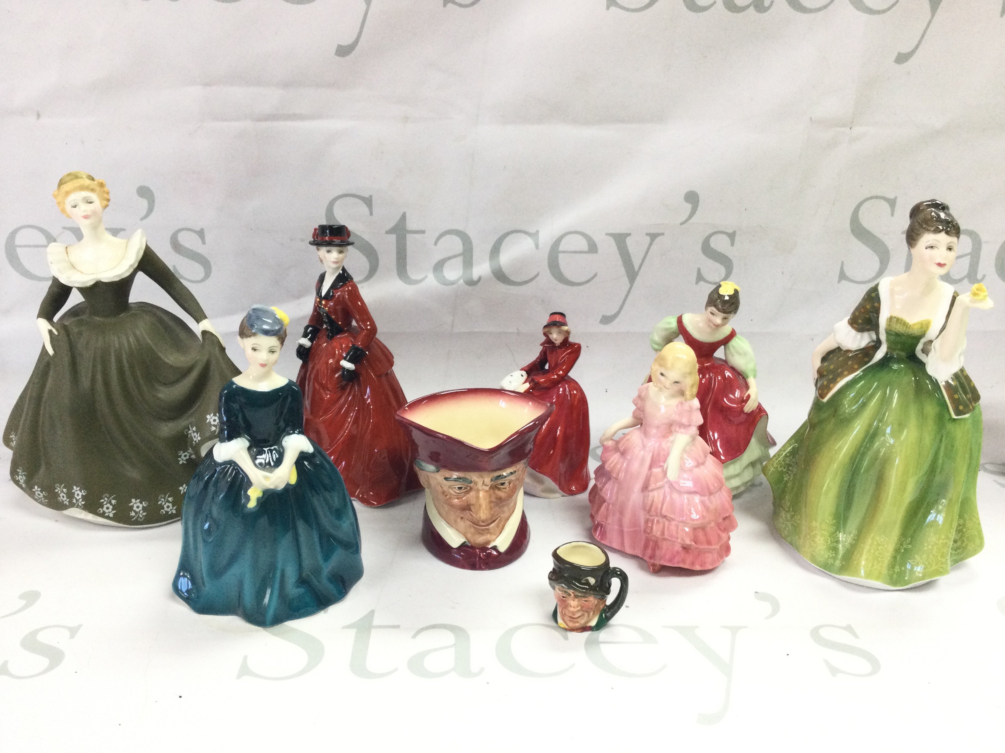 A collection of Royal Doulton and Worcester porcelain figures including Fleur, Cherrie, Fair Maiden, Rose (damaged) and character jugs. This lot cannot be posted