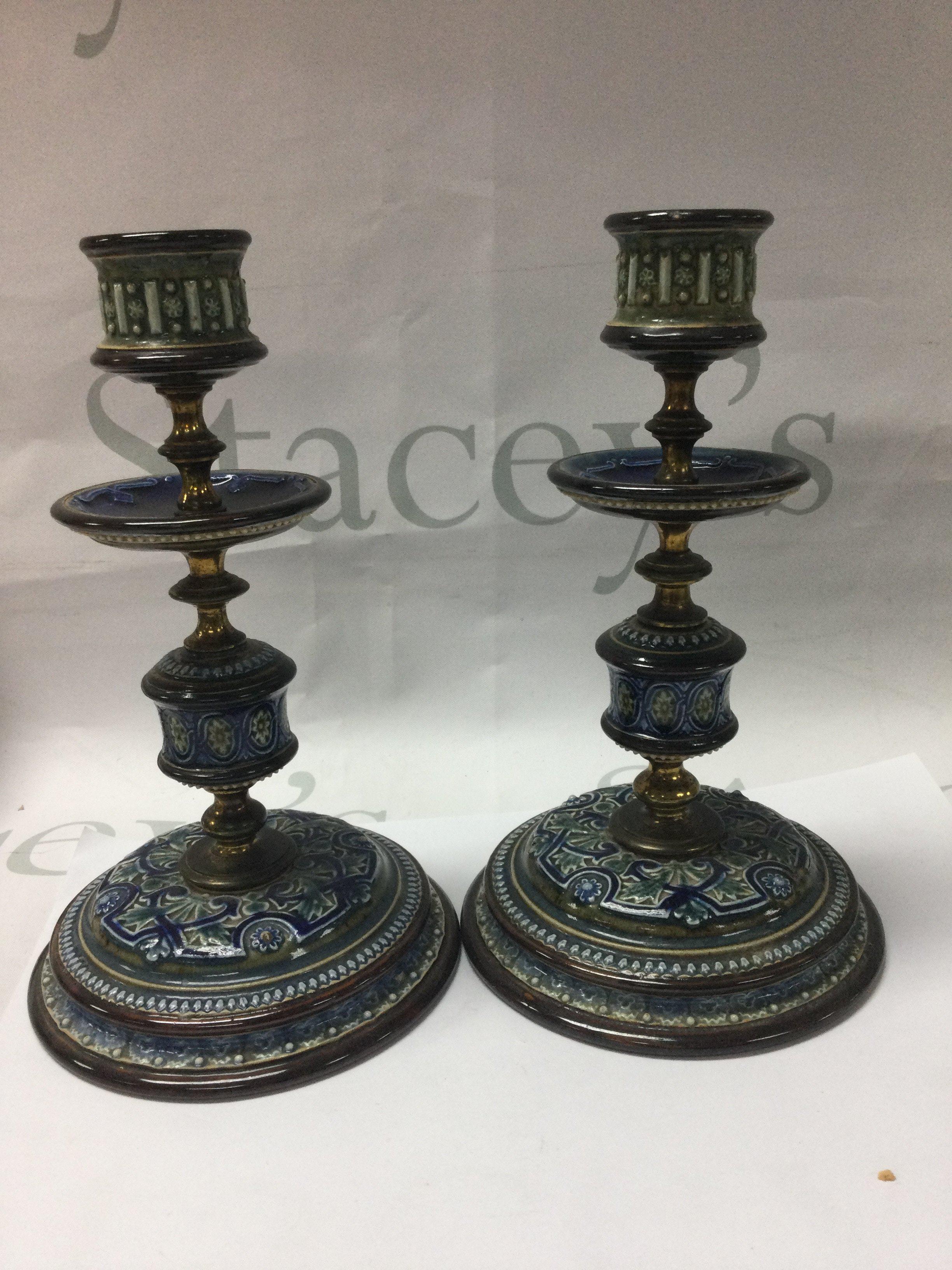 A pair of Doulton Lambeth candle sticks 2O cm