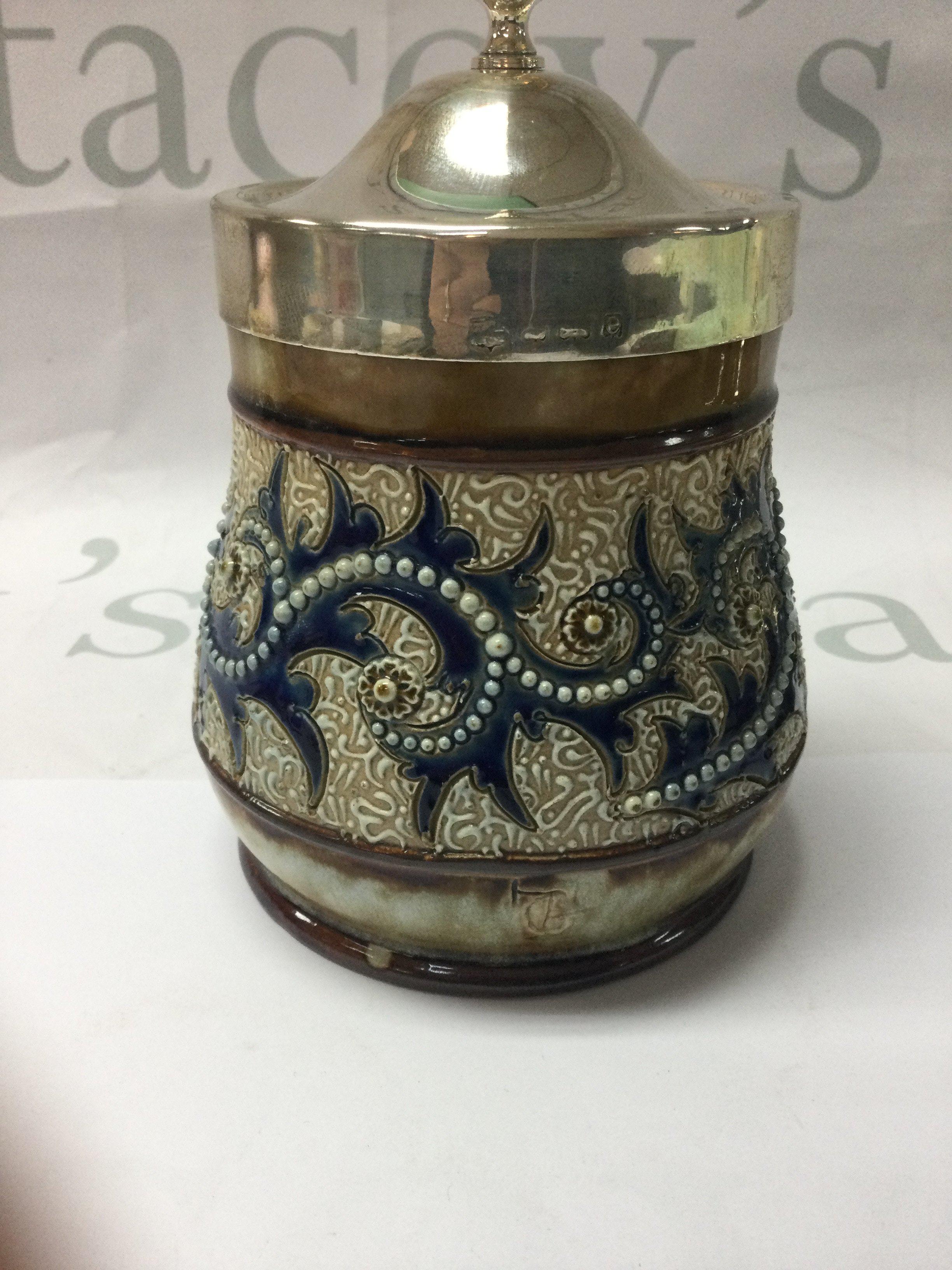 A Doulton Lambeth George tinworth preserve jar . With silver plated Lid and silver rim . 12 cm .