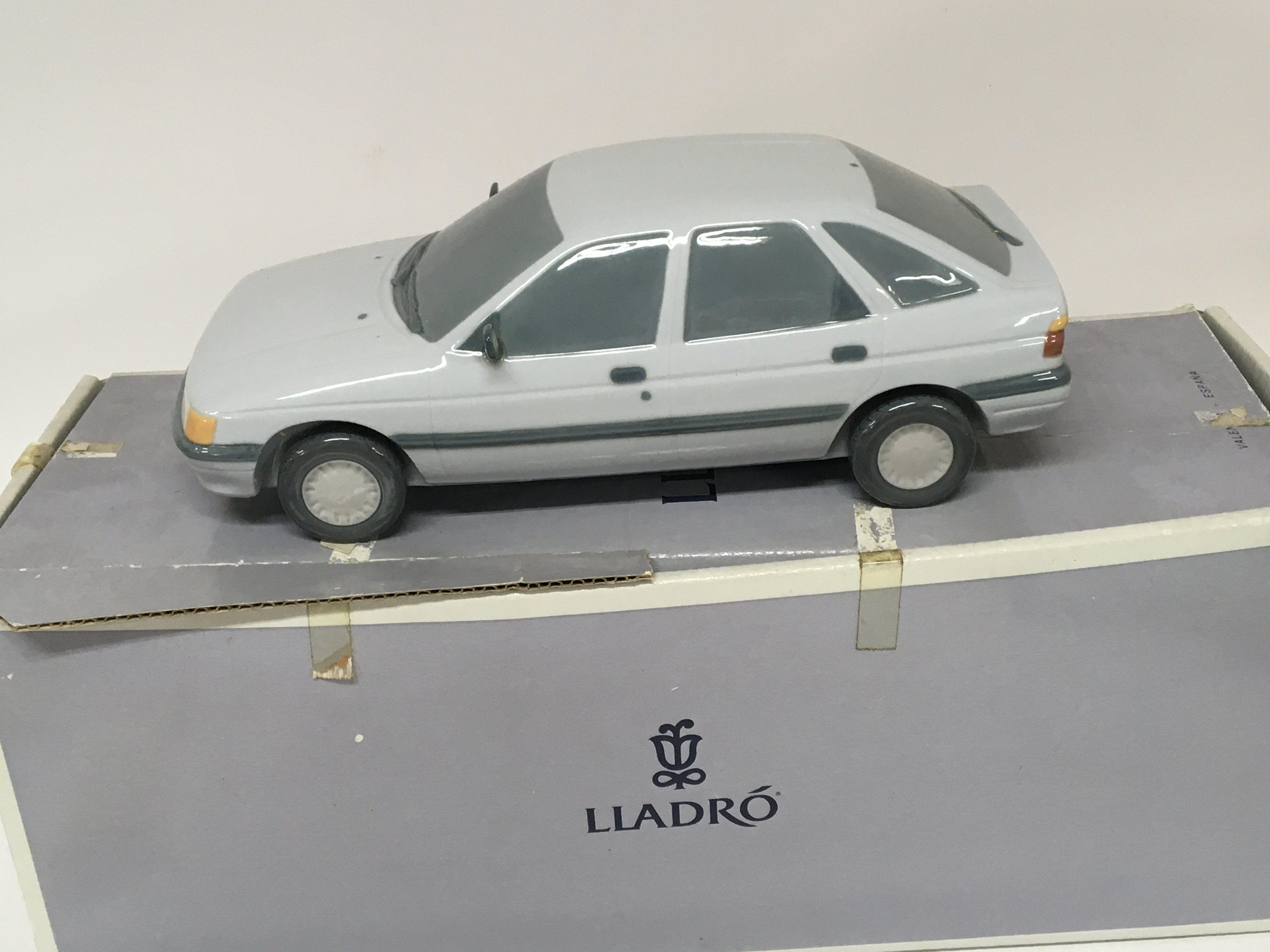 A Lladro porcelain model of a Ford Escort car. With box no damage.