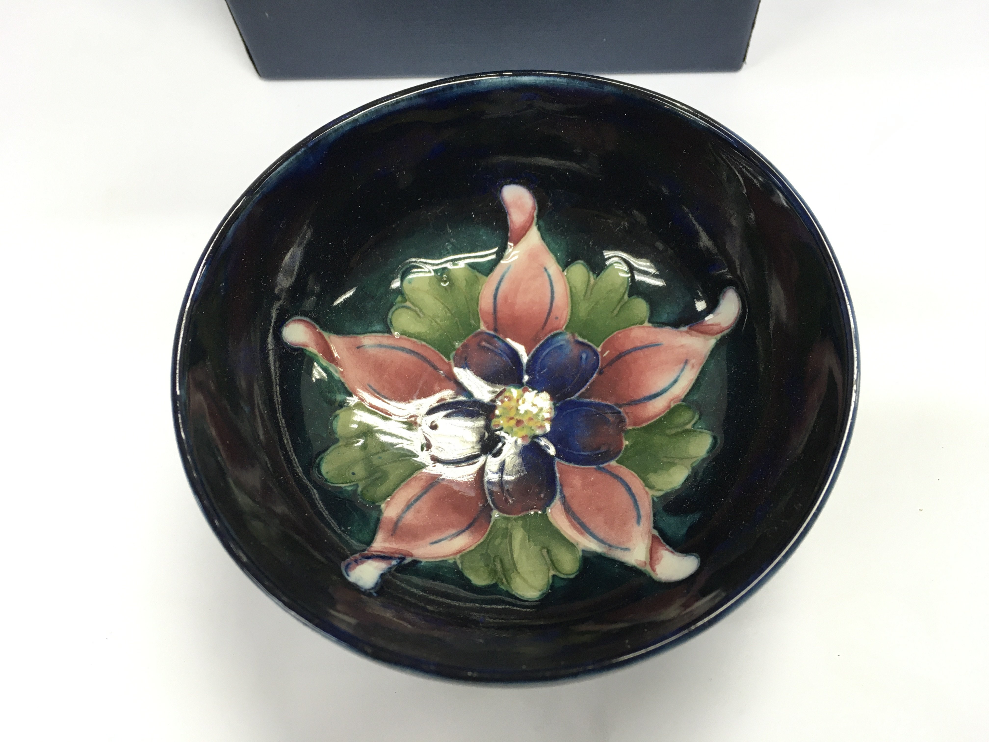 A small moorcroft dish with box. Approximately 10.5cm wide.