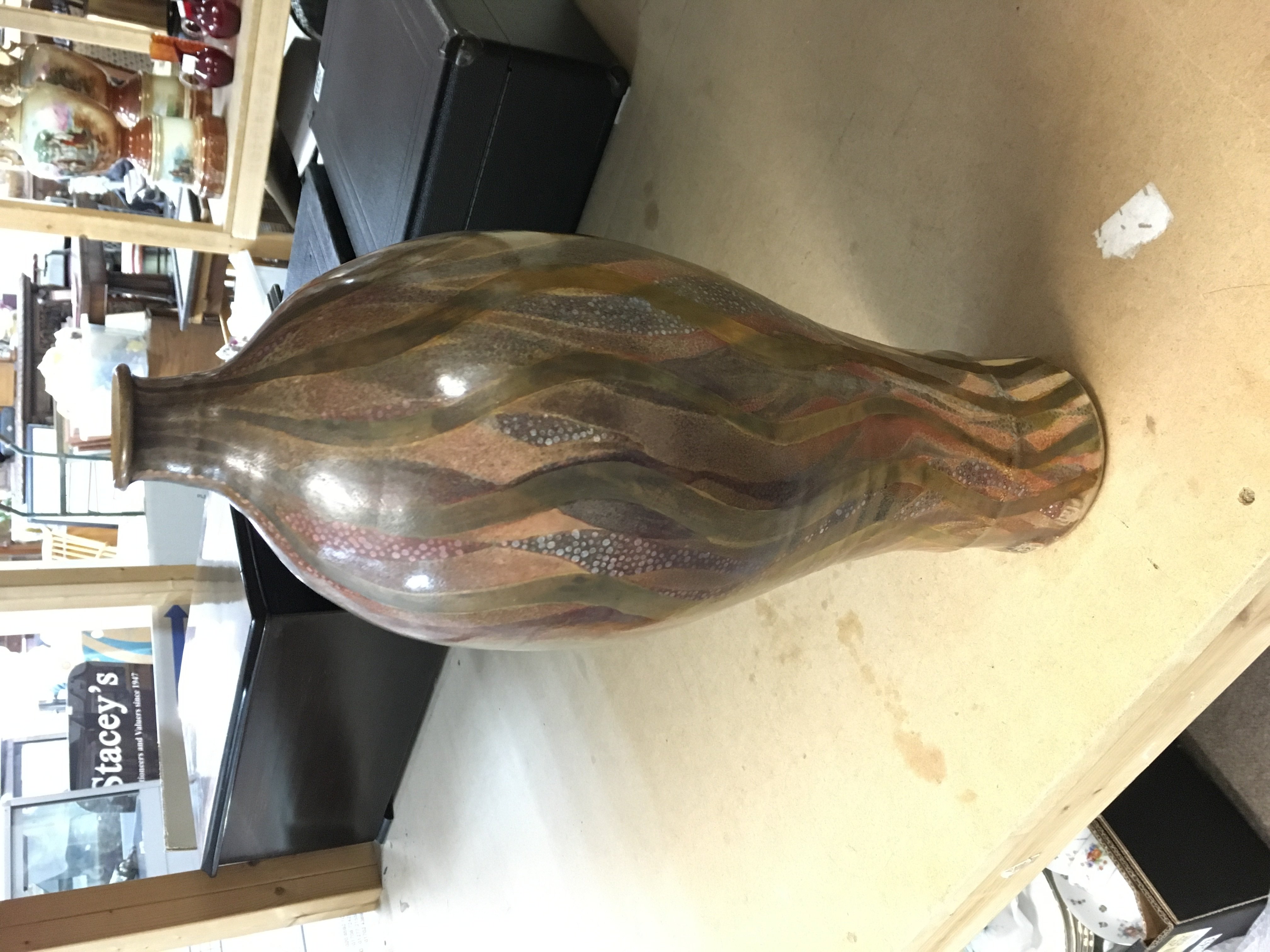 Sutton Taylor Cinnabar earthware bottle covered in lustred polychrome flame like decoration. Impressed ST and LH for Lotherton hall 1980s 42.5cm tall. Good condition.