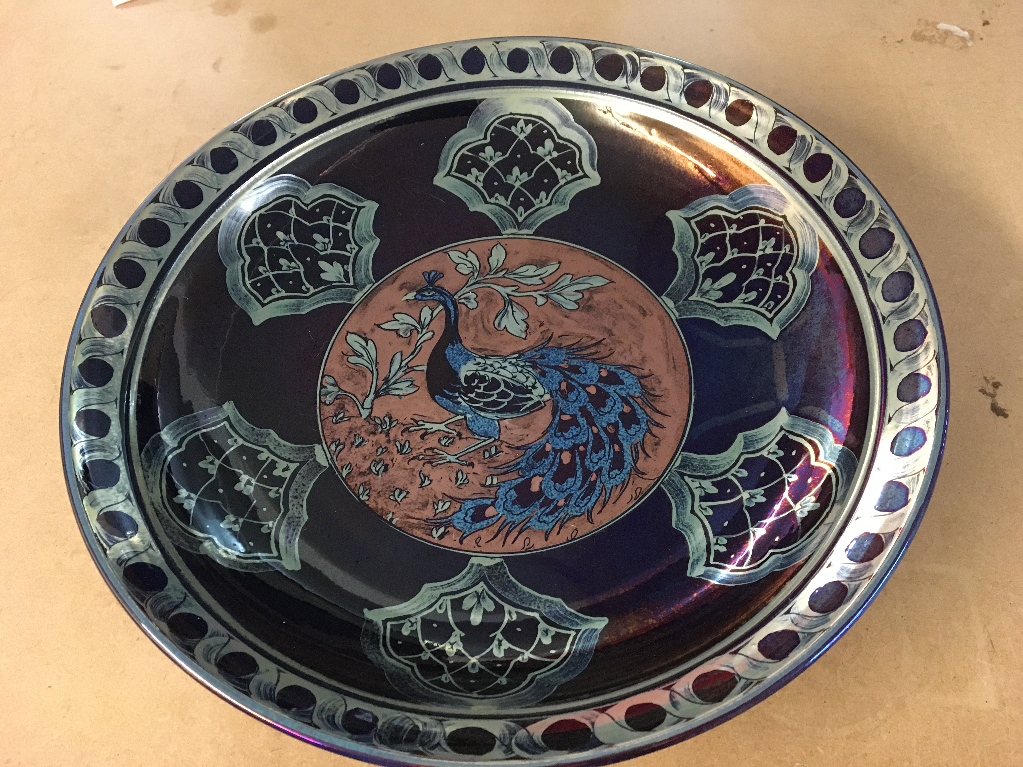 A Hege Jonathan Chiswell Jones Peacock lustre charger. 39cm diameter