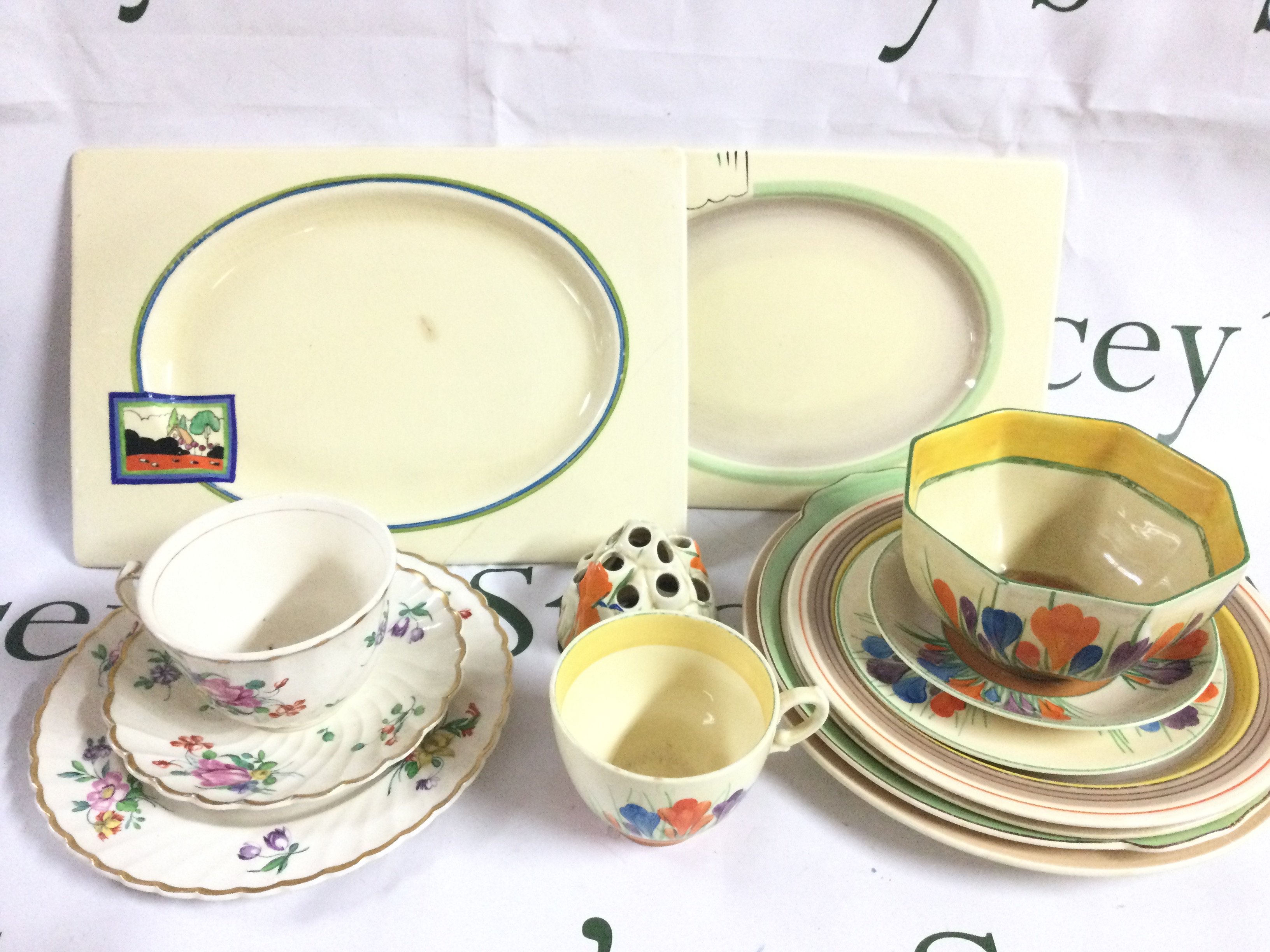 A collection of Clarice Cliff ceramics including dishes, plates, cups etc. The Biarritz Royal Staffordshire, Crocus bowl, . Some damage.