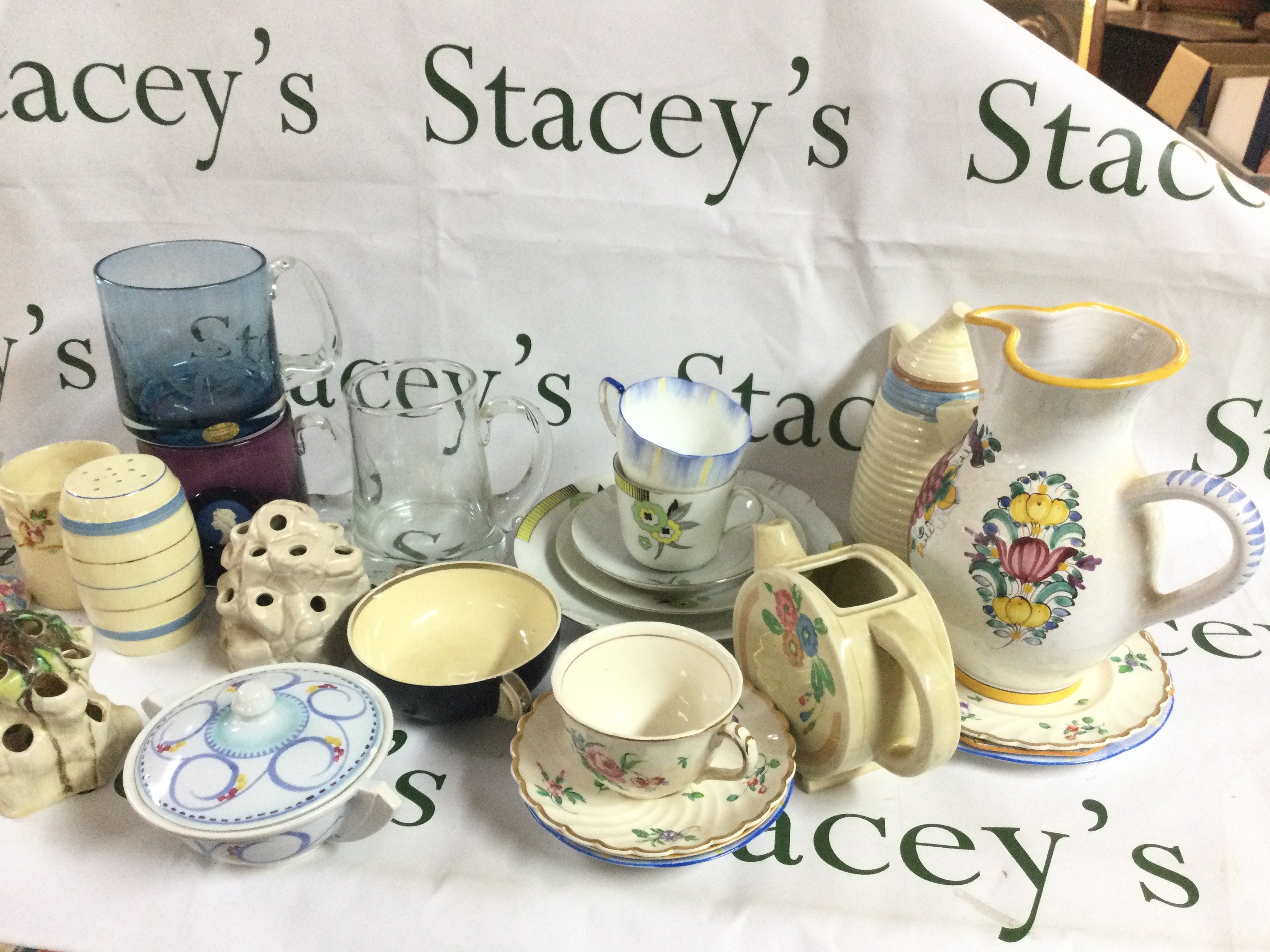 A collection of ceramics including Shelley flower holders, reproduced old Bristol porcelain designed by Duvivier Circa 1770 by Clarice Cliff cup and saucer, Newport Clarice tea jug, Clarice vase etc