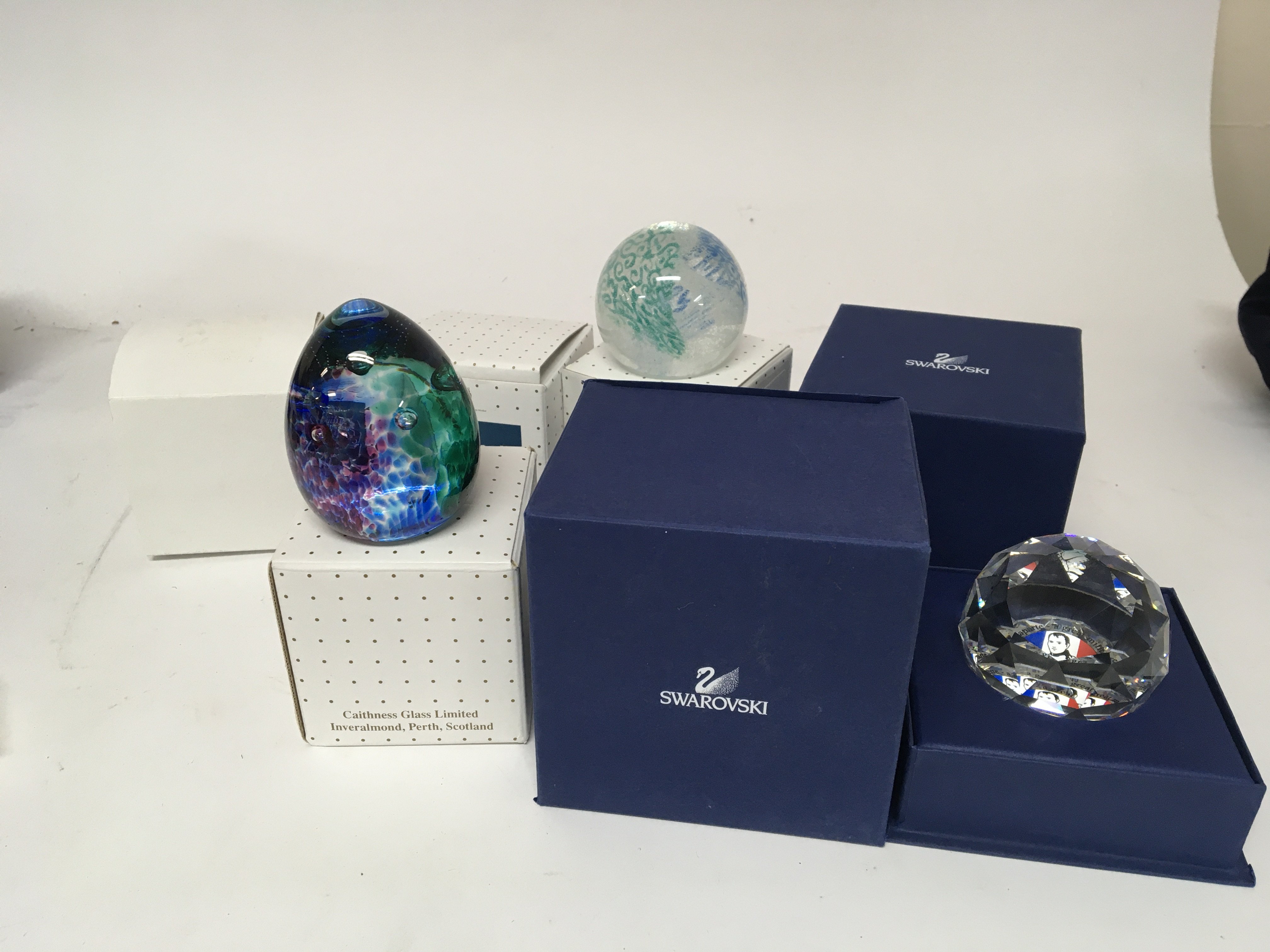 Two boxed Swarovski paperweights and four Caithness paperweights Lace Tapestry Fortune feathers SB and Weaver (6)