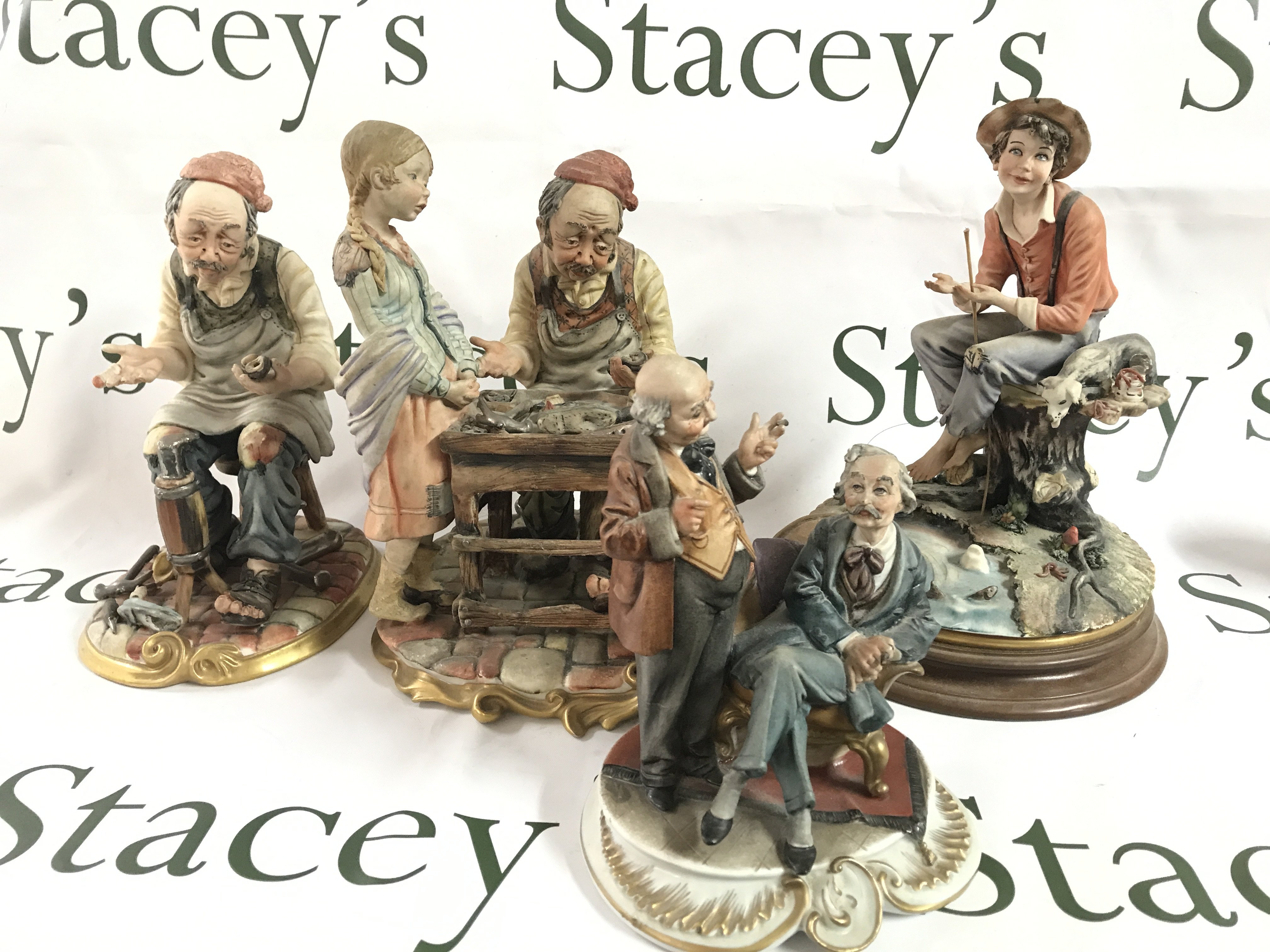 Four Capodimonte figures including fishing boy, Gentlemen gossiping, Cobbler etc. this lot cannot be posted