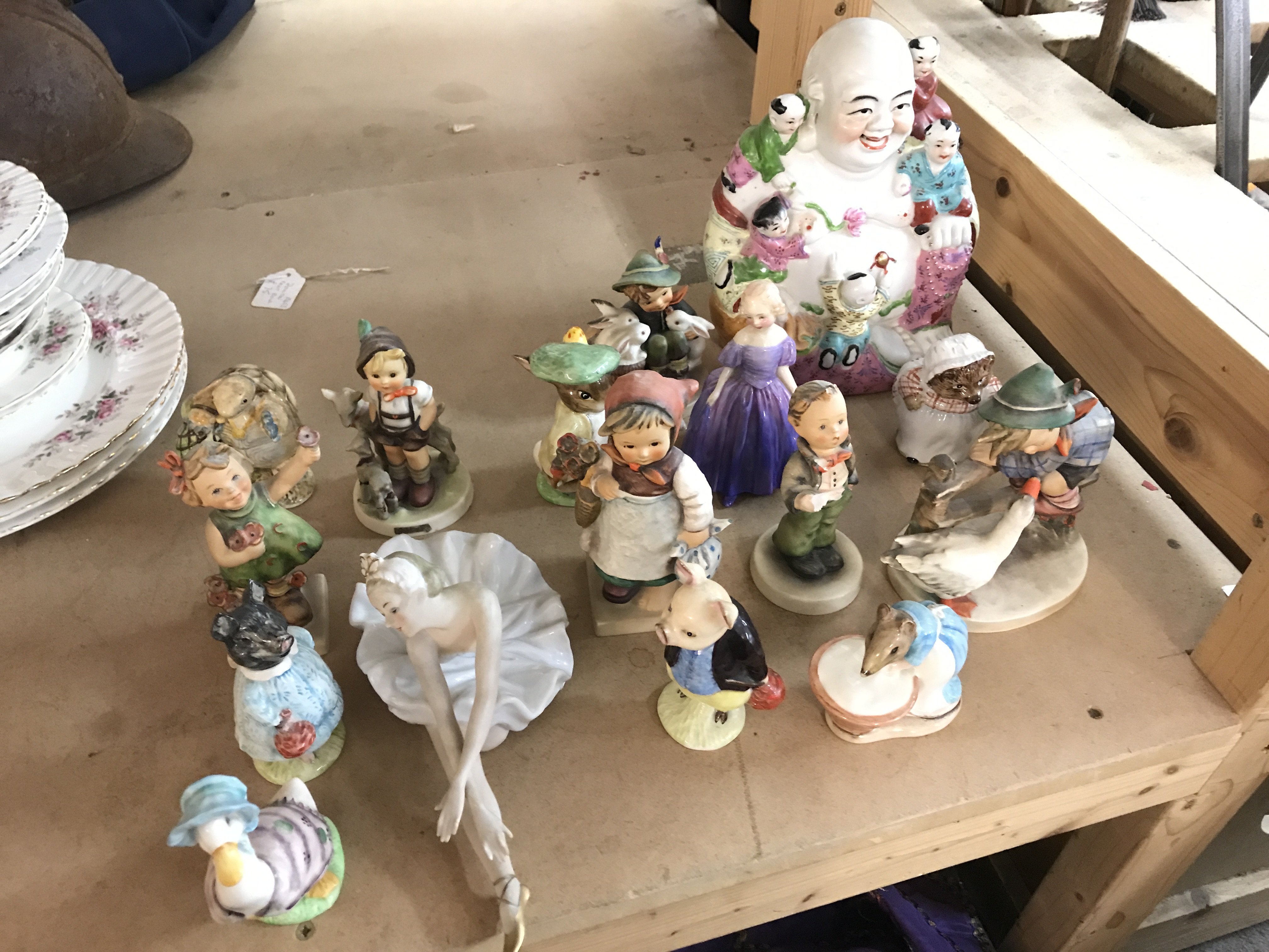A collection of ceramic figures including Doulton , Goebel and Beswick