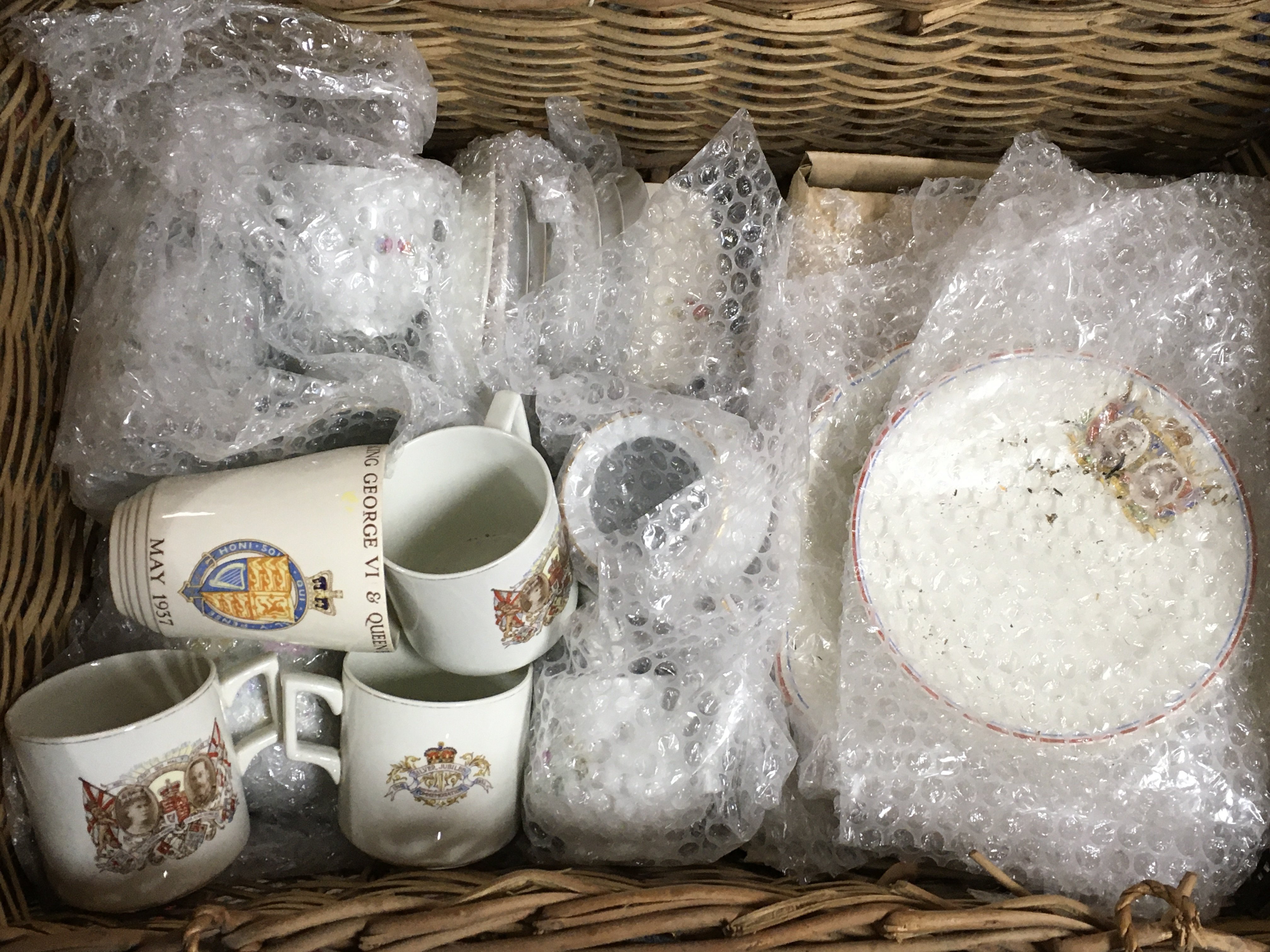 A basket containing Royal Commemorative ceramics including plates, cups etc